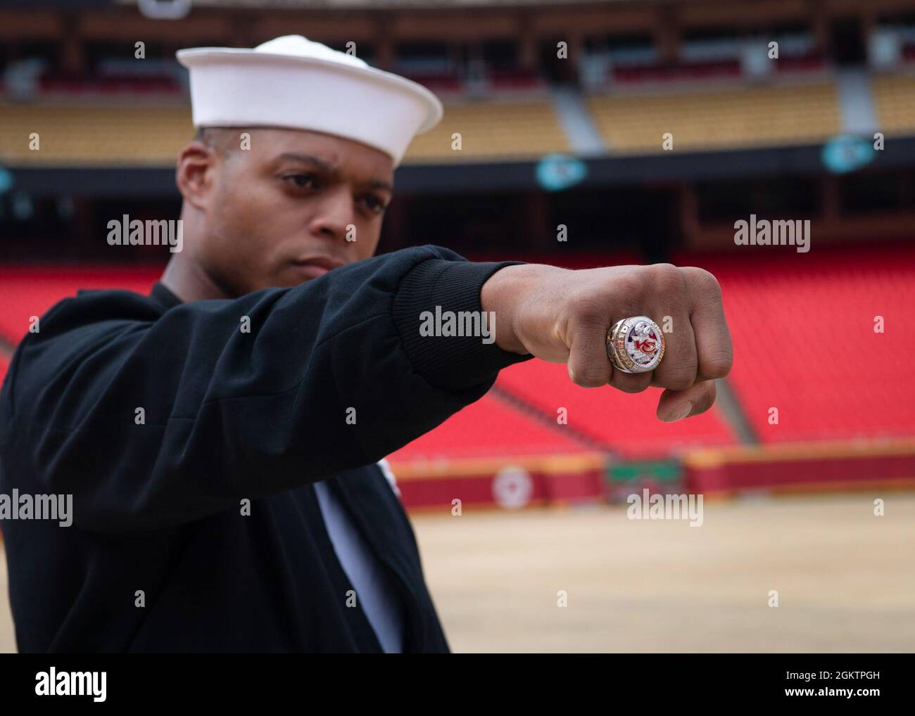 Aviation Structural Mechanic 3rd Class Kristopher Williams, assigned to U.S. Navy Ceremonial Guard “Drill Team Platoon”, poses for a photo with a Kansas City Chiefs Superbowl ring during a tour of Government Employees Health Association Field at Arrowhead Stadium in Kansas City, Missouri July 1, 2021. GEHA Field at Arrowhead Stadium is home to the Kansas City Chiefs NFL team. The event was part of Kansas City Navy Week, the first in-person Navy Week since the beginning of the COVID-19 pandemic, bringing Sailors from different Navy units across the U.S. to conduct focused outreach with members Stock Photo