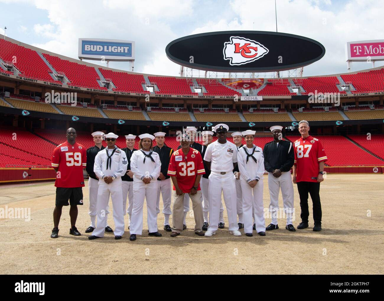 Sailors assigned to USS Harry S. Truman (CVN 75)  and U.S. Navy Ceremonial Guard “Drill Team Platoon” pose for a photo with Kansas City Chief Ambassadors during a tour of Government Employees Health Association Field at Arrowhead Stadium in Kansas City, Missouri July 1, 2021. GEHA Field at Arrowhead Stadium is home to the Kansas City Chiefs NFL team. The event was part of Kansas City Navy Week, the first in-person Navy Week since the beginning of the COVID-19 pandemic, bringing Sailors from different Navy units across the U.S. to conduct focused outreach with members of the community. Navy Wee Stock Photo