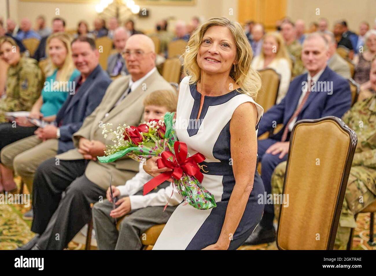 Col. Steven Anderson, outgoing 688th Cyberspace Wing Commander’s wife, Angela Anderson receives red roses as part of the 688th Cyberspace Wing transfer of authority July 1. 2021 at Joint Base San Antonio-Lackland, Texas. Stock Photo