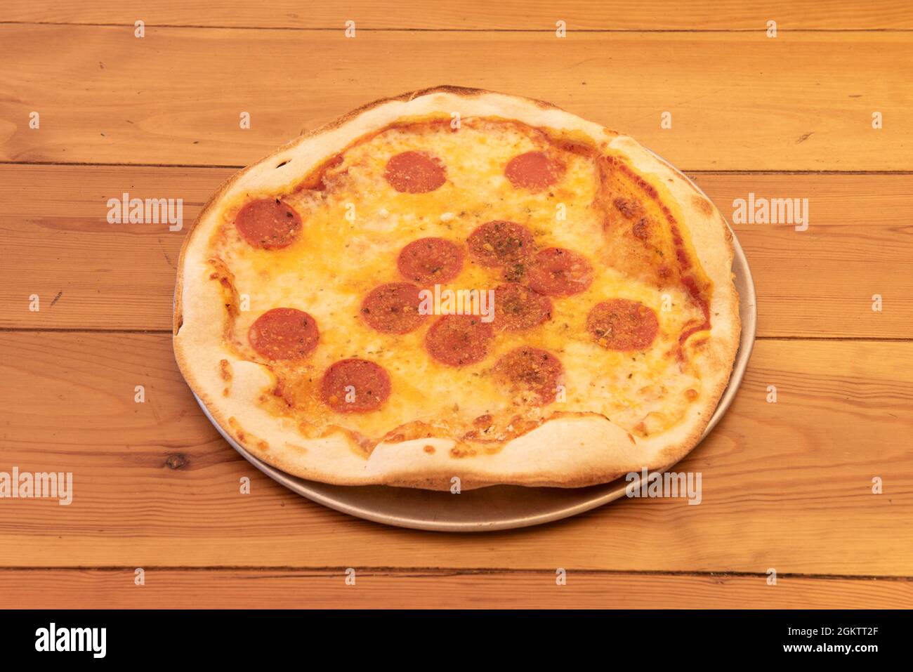 Simple Italian Thin Crust Pizza with Lots of Spicy Pepperoni on Top of