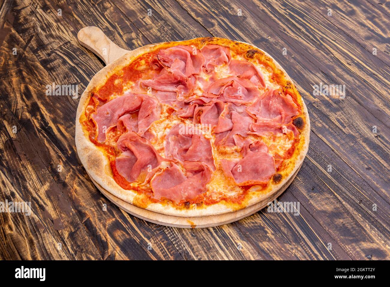 Italian prosciutto pizza with lots of ham and lots of melted mozzarella