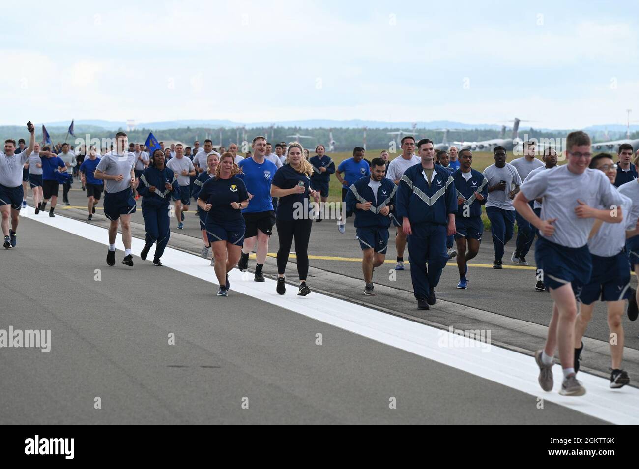 U.S. Air Force Airmen run down the flightline at Ramstein Air base, Germany, July 1, 2021. Airmen from all squadrons in the 86th Airlift Wing participated in the RUNway 5K run to kick off the Fourth of July weekend. Stock Photo