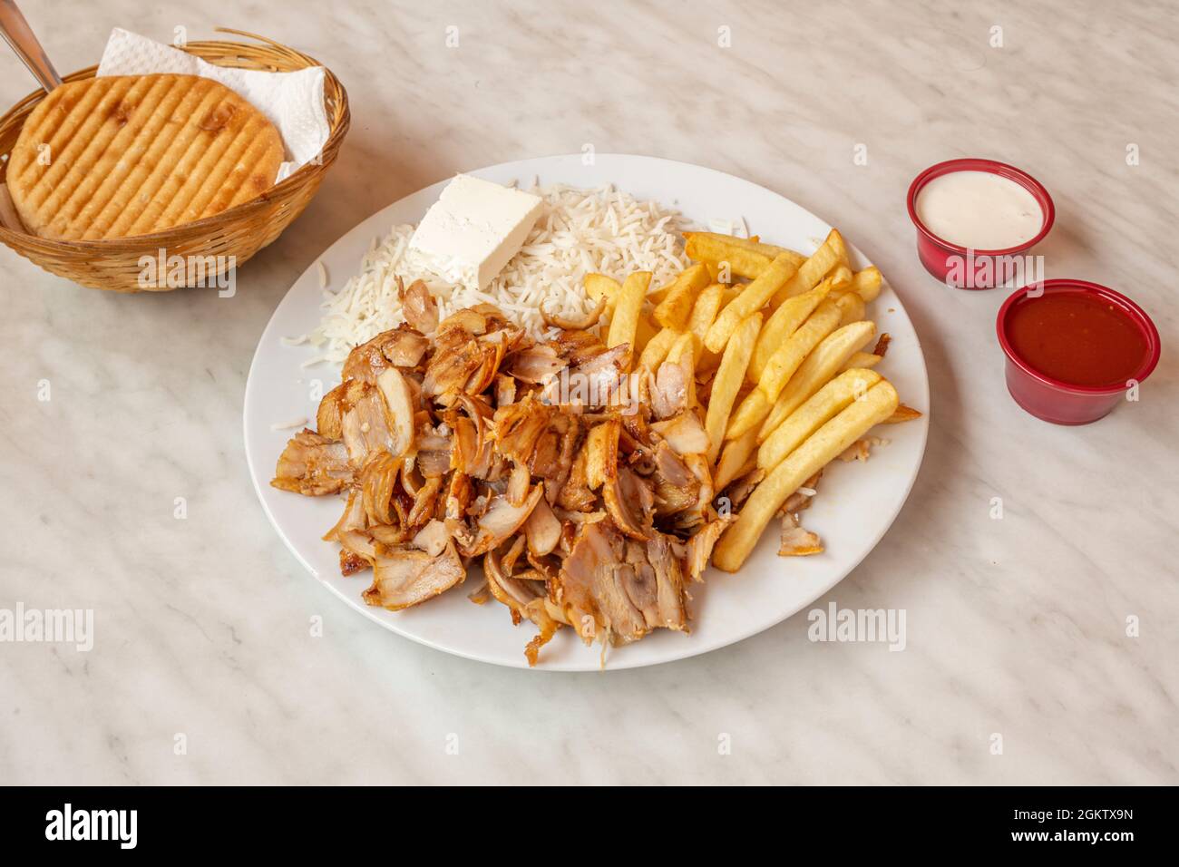 Menu kebab plate with chicken meat, fried potatoes, fresh cheese and