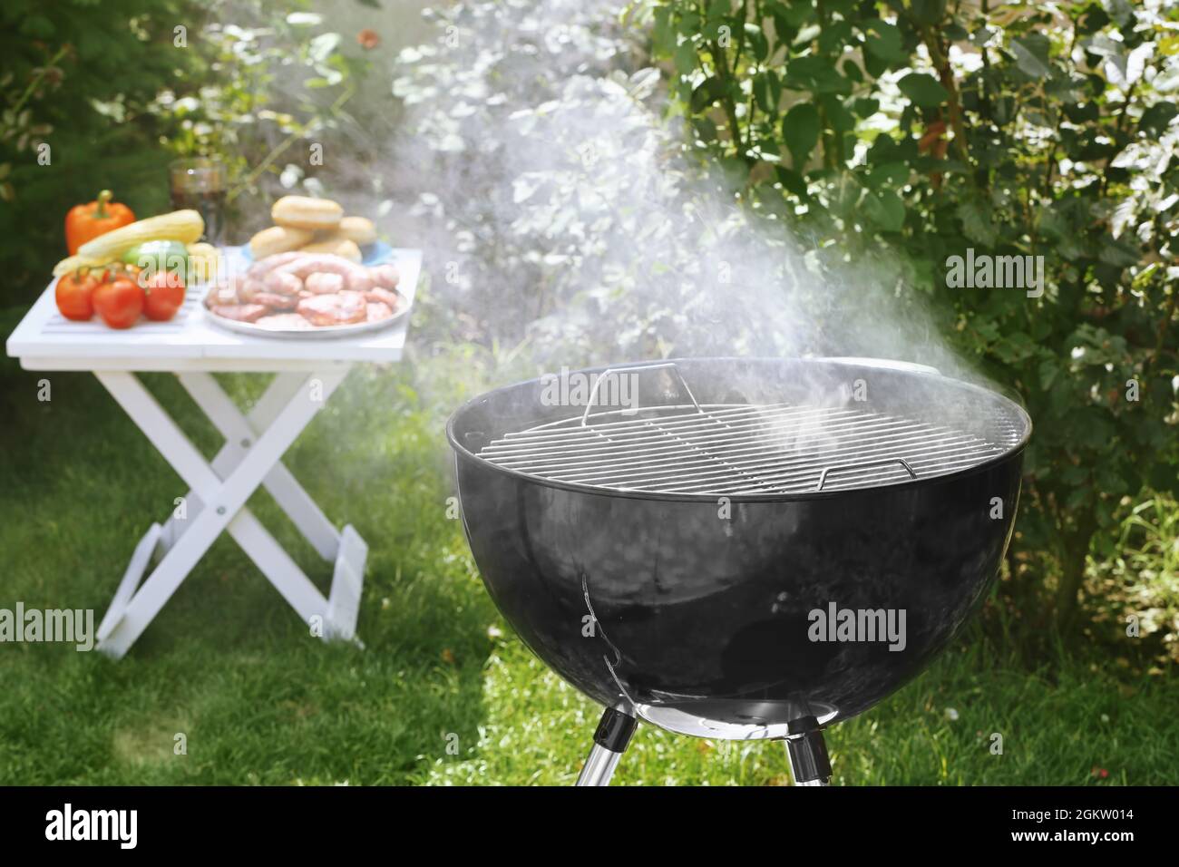 Barbecue grill with smoke on backyard Stock Photo - Alamy