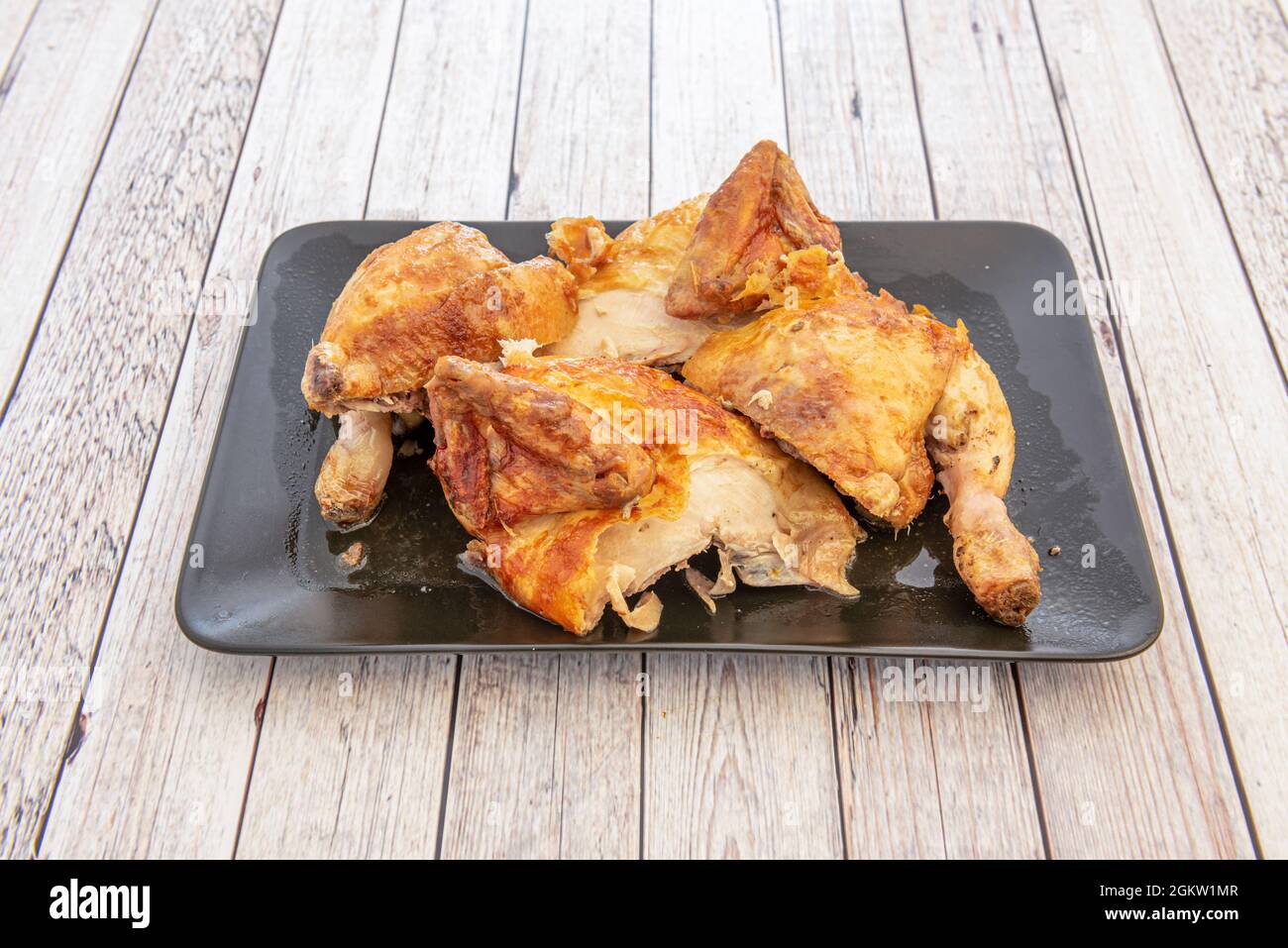 Whole roast chicken chopped with its crispy skin and its barbecue sauce