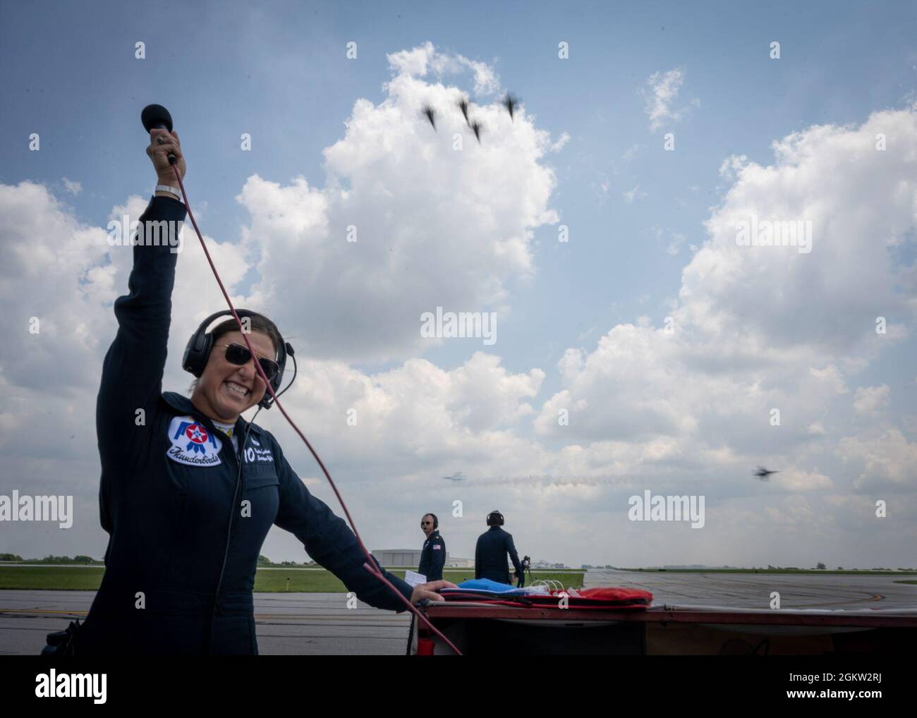 Capt. Katie Moorkamp, United States Air Force Air Demonstration Squadron 'Thunderbirds' Executive Officer, raises a microphone after narrating the demonstration at the KC Air Show in New Century, Kansas, July 3, 2021. In addition to her primary duties as the executive officer, Moorkamp also narrates during air shows Stock Photo