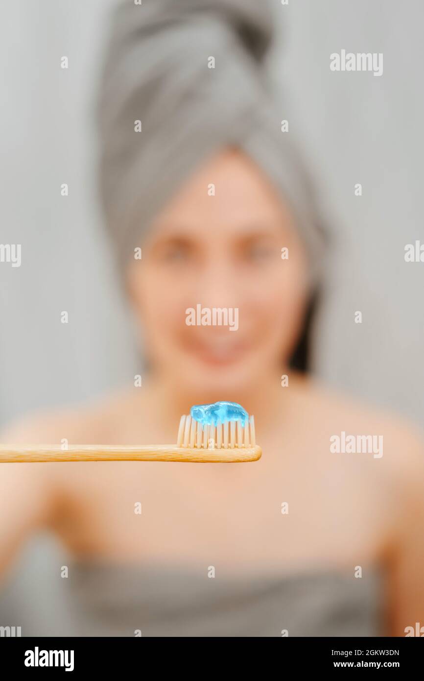 Bamboo toothbrush with blue paste for whitening and treatment of caries. Stock Photo