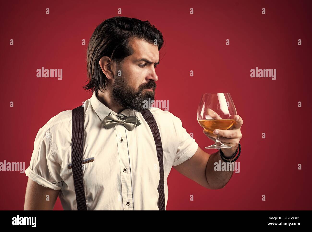 handsome guy hipster with moustache and beard drink kignac, barkeeper Stock Photo