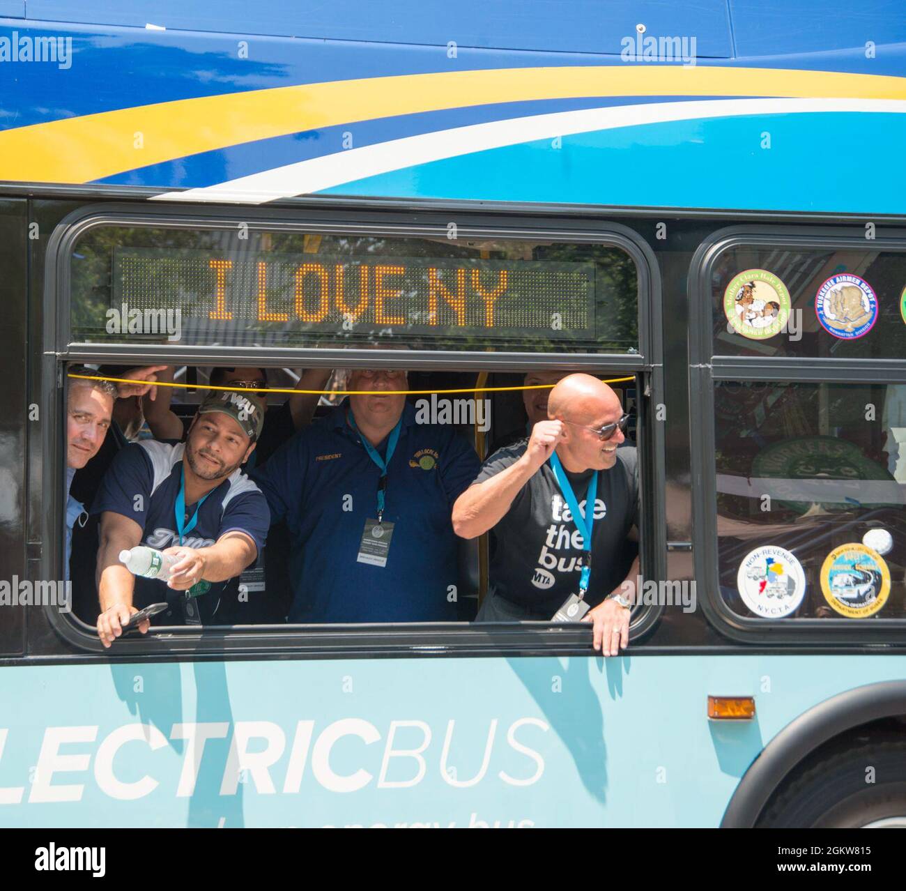 A group of Metropolitan Transportation Authority (MTA) workers wave and ...
