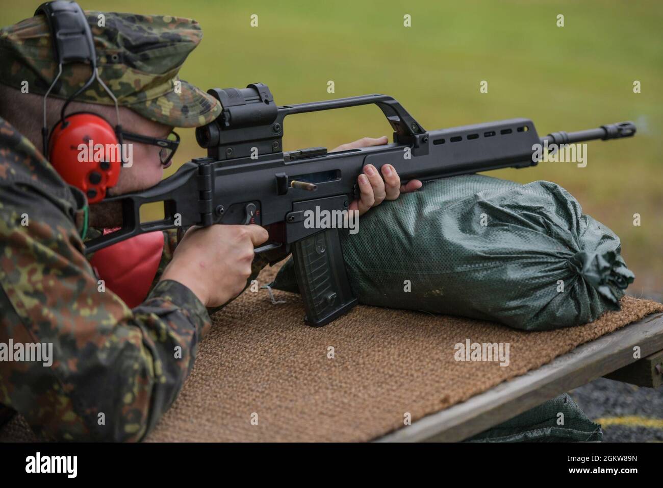 A German soldier fires a G36 rifle during qualification for the 'Schuetzenschnur', the German Armed Forces badge of marksmanship, at the 7th Army Training Command’s Grafenwoehr Training Area, Germany, July 7, 2021. Stock Photo