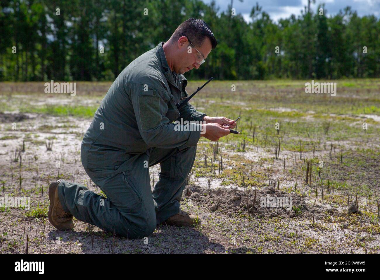 U.S. Marine Corps Master Sgt. Carlos Villarreal, an Explosive Ordnance Disposal (EOD) technician with Headquarters and Headquarters Squadron, prepares homemade explosives for a post blast analysis training event on Marine Corps Air Station Cherry Point, North Carolina, July 7, 2021. The explosives were detonated and analyzed to increase proficiency in identifying Improvised Explosive Devices during EOD operations. Stock Photo