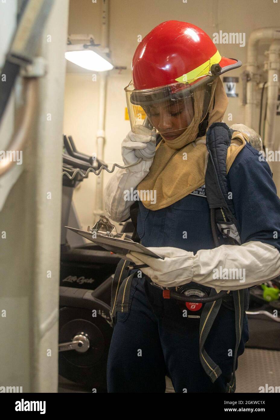 EAST CHINA SEA (July 8, 2021) A Sailor reports the status of a simulated fire aboard Arleigh Burke-class guided-missile destroyer USS John S. McCain (DDG 56) during a firefighting drill. McCain is assigned to Task Force 71/Destroyer Squadron (DESRON) 15, the Navy’s largest DESRON and the U.S. 7th Fleet’s principal surface force. Stock Photo