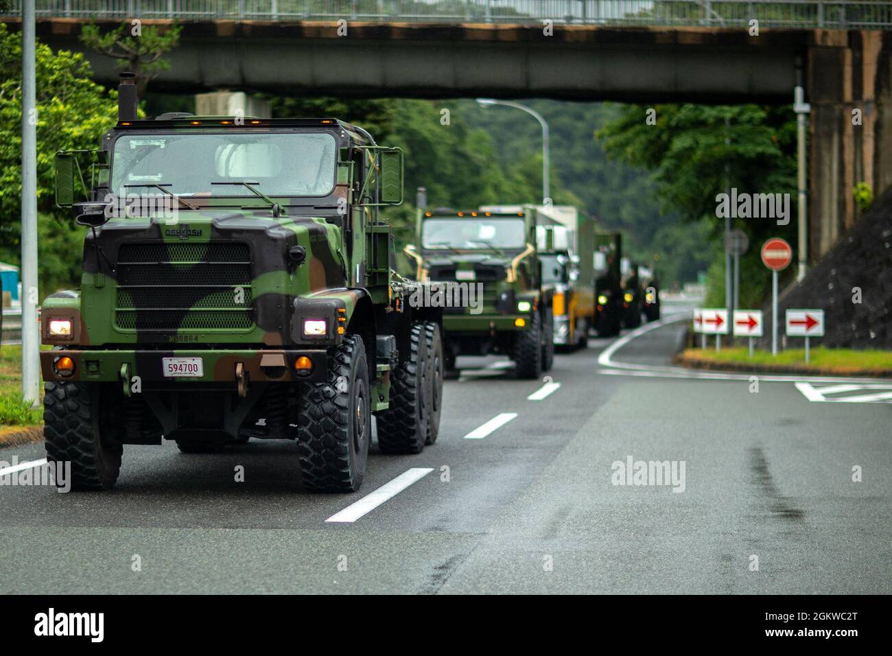 U.S. Marine Corps 7-ton trucks with Marine Wing Support Squadron (MWSS) 171 pull into a rest stop during a convoy from Marine Corps Air Station Iwakuni to Combined Arms Training Center (CATC) Camp Fuji, Japan, July 9, 2021. U.S. Marines with MWSS-171 began Eagle Wrath 21, a two-week exercise at CATC Camp Fuji to maintain a high level of proficiency and combat readiness. Stock Photo