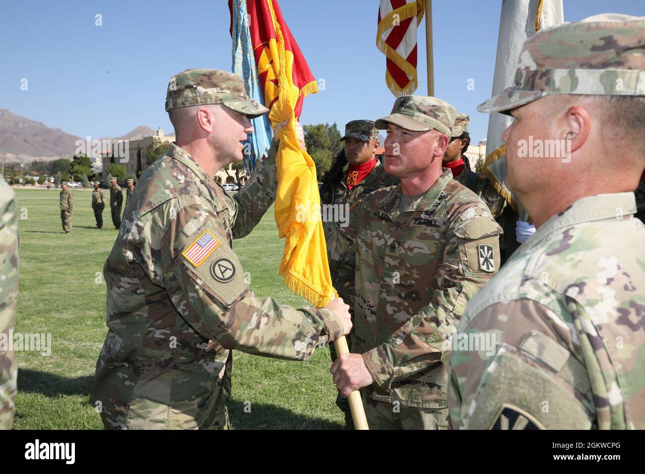 Col. Timothy L. Woodruff, incoming brigade commander, 11th Air Defense Artillery Brigade, 32d Army Air and Missile Defense Command, hands off the Brigade guidon to Command Sgt. Maj. Robert Walker during the change of command ceremony. Col. John L. Dawber, outgoing commander, 11th ADA BDE, relinquished command to Woodruff, July 9, 2021, on Noel Parade Field, Fort Bliss, Texas. Stock Photo