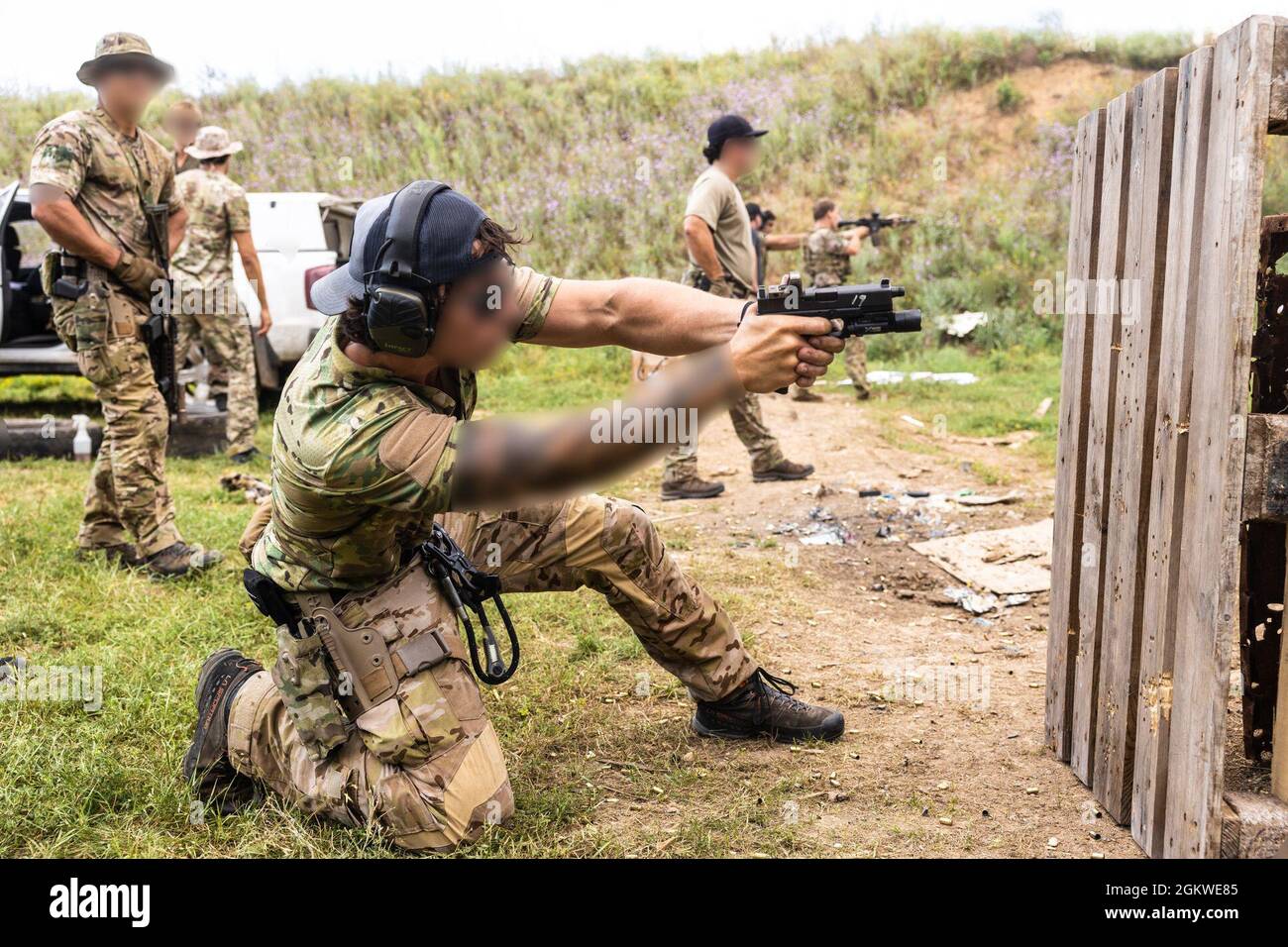 A U.S. Navy SEAL fires custom Glock 17 pistol at a range during exercise Sea Breeze 21 in Ochakiv, Ukraine, July 8, 2021. Sea Breeze 21 is a U.S. and Ukraine co-hosted multinational maritime exercise held in the Black Sea designed to enhance interoperability of participating nations and strengthen maritime security within the region. Stock Photo