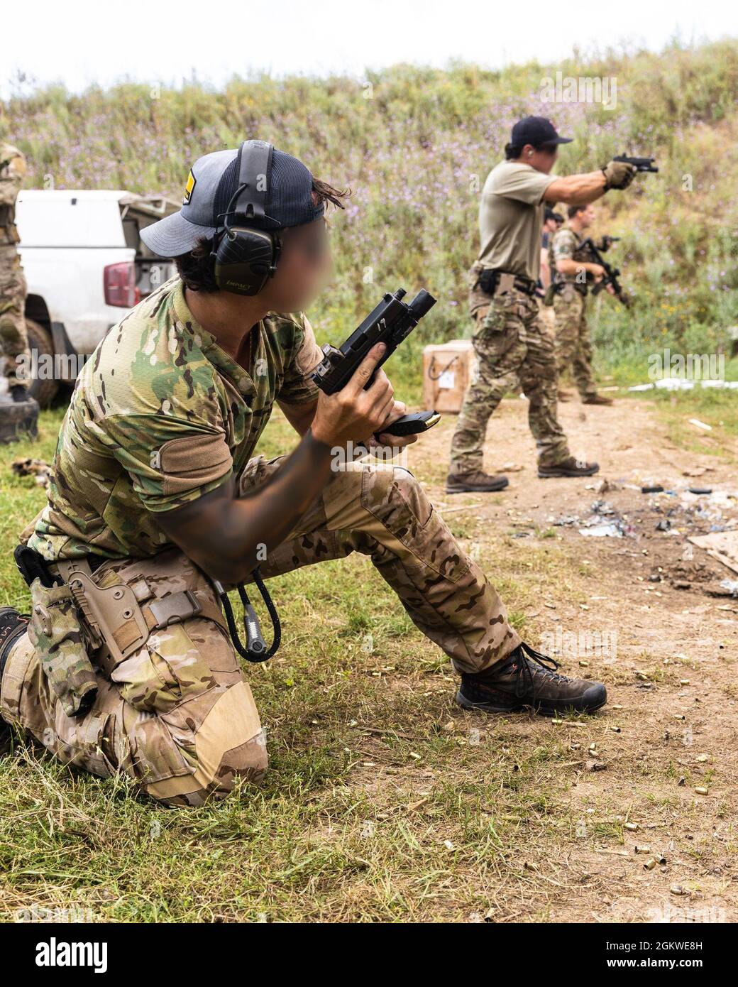 A U.S. Navy SEAL reloads a custom Glock 17 pistol at a range during exercise Sea Breeze 21 in Ochakiv, Ukraine, July 8, 2021. Sea Breeze 21 is a U.S. and Ukraine co-hosted multinational maritime exercise held in the Black Sea designed to enhance interoperability of participating nations and strengthen maritime security within the region. Stock Photo