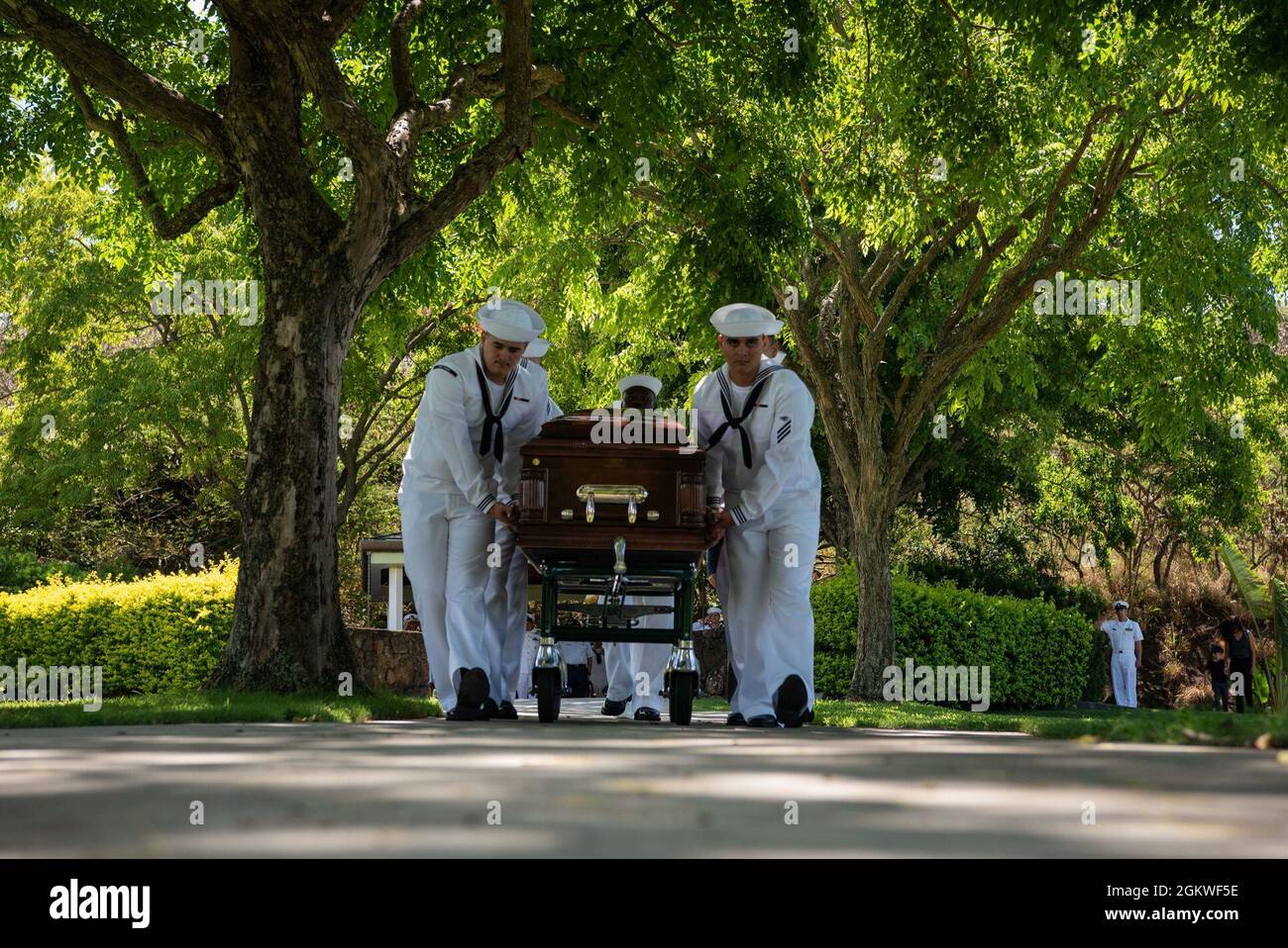 Sailors assigned to U.S. Navy Region Hawaii escort the casket of U.S. Navy Musician 2nd Class Charlton Hanna Ferguson, 19, of Kosciusko, Missouri during a funeral held at the National Memorial Cemetery of the Pacific, Honolulu, Hawaii, July 9, 2021. Ferguson was assigned to the USS Oklahoma when it sustained fire from Japanese aircraft and multiple torpedo hits. The result of the attack capsized the battleship causing the deaths of 429 crew members on Dec. 7, 1941, at Ford Island, Pearl Harbor. Ferguson was identified Dec. 17, 2020 through DNA analysis by the Defense POW/MIA Accounting Agency Stock Photo