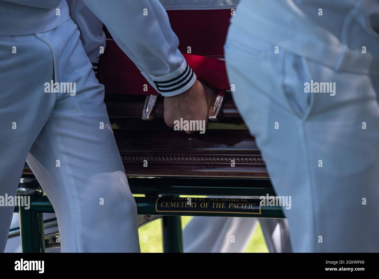 Sailors assigned to U.S. Navy Region Hawaii escort the casket of U.S. Navy Musician 2nd Class Charlton Hanna Ferguson, 19, of Kosciusko, Missouri during a funeral held at the National Memorial Cemetery of the Pacific, Honolulu, Hawaii, July 9, 2021. Ferguson was assigned to the USS Oklahoma when it sustained fire from Japanese aircraft and multiple torpedo hits. The result of the attack capsized the battleship causing the deaths of 429 crew members on Dec. 7, 1941, at Ford Island, Pearl Harbor. Ferguson was identified Dec. 17, 2020 through DNA analysis by the Defense POW/MIA Accounting Agency Stock Photo