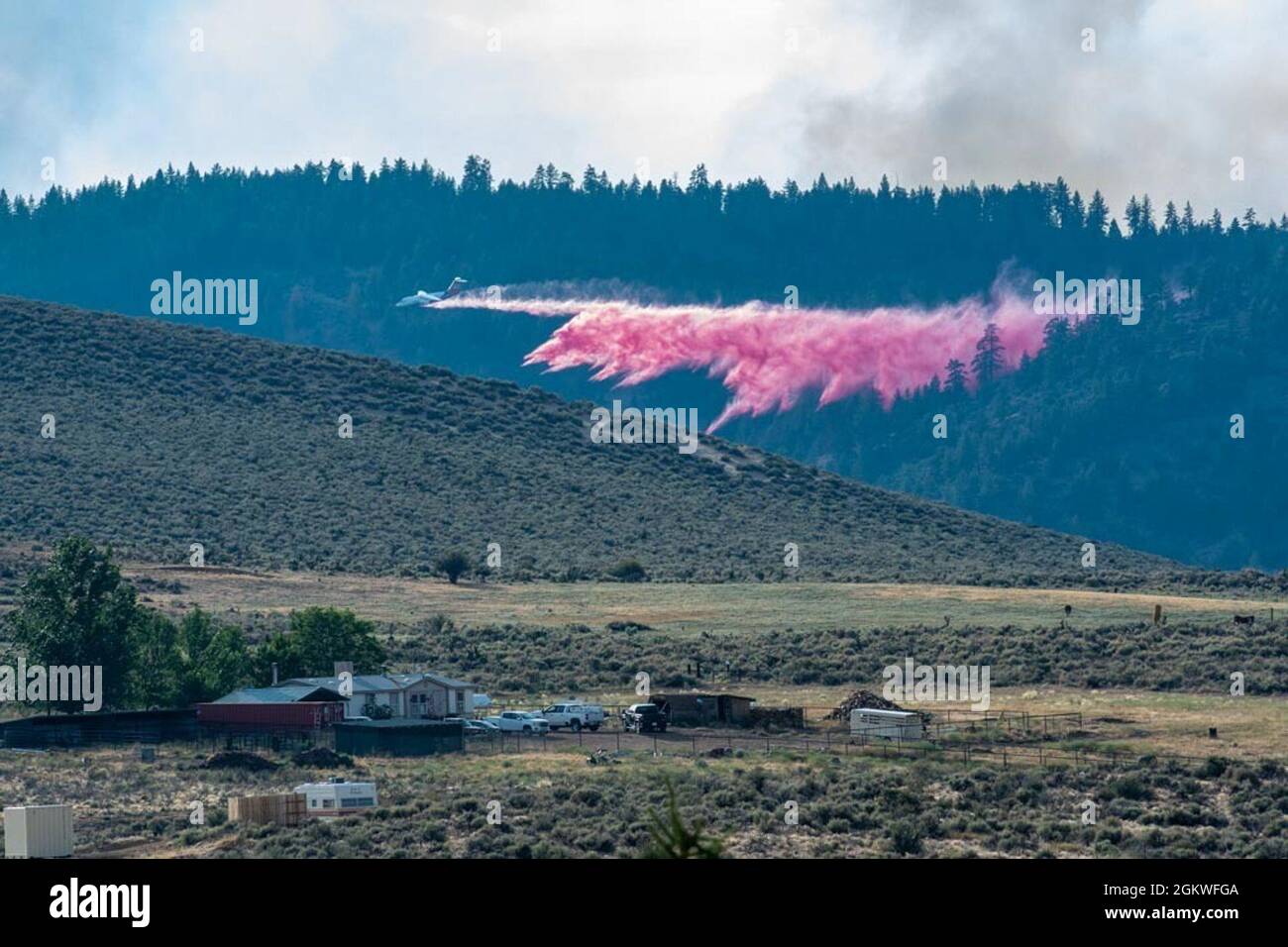 A civilian air tanker drops retardant on the Beckwourth Complex Fire