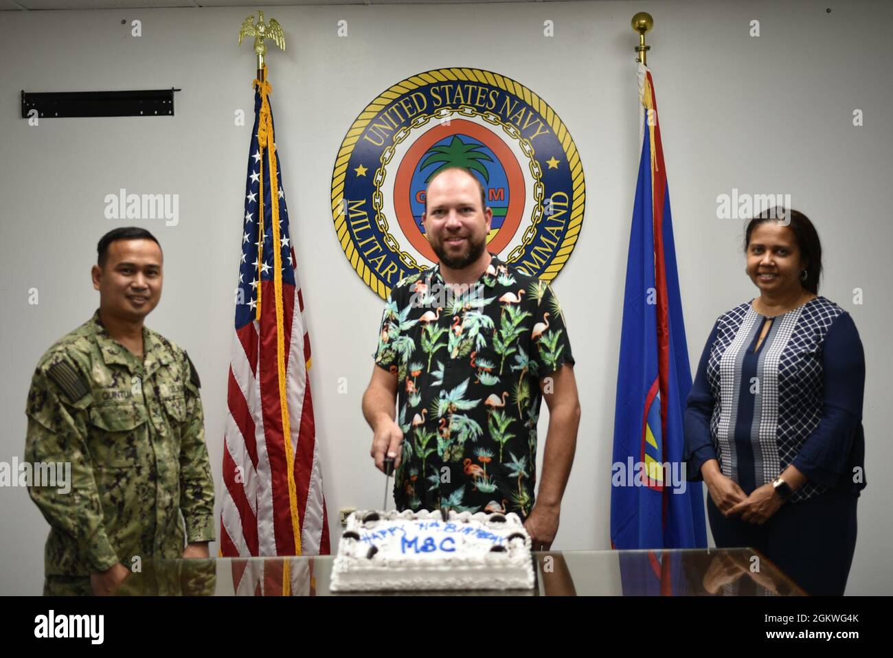 From left, Personnel from Ship Support Unit Guam, HM2 Perpetuo Quintua, Christopher Boschert, and Jaqueline Kinloch-Miller, join the command in celebrating Military Sealift Command's birthday on July 9.  SSU Guam is part of MSC Far East. “I am extremely proud of everyone assigned to Military Sealift Command Far East, whether active duty or civilian, ashore or afloat, and salute and celebrate their service,” Capt. Samuel F. de Castro, commodore, MSC FE, said. Quintua was recently selected as MSC Far East's junior Sailor of the quarter.  Boschert and Kinloch-Miller earned civilian of the quarter Stock Photo