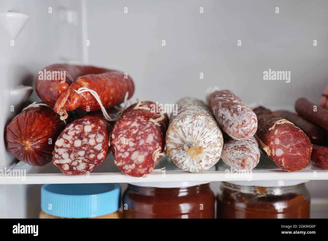 Smoked sausages on shelf in refrigerator Stock Photo Alamy
