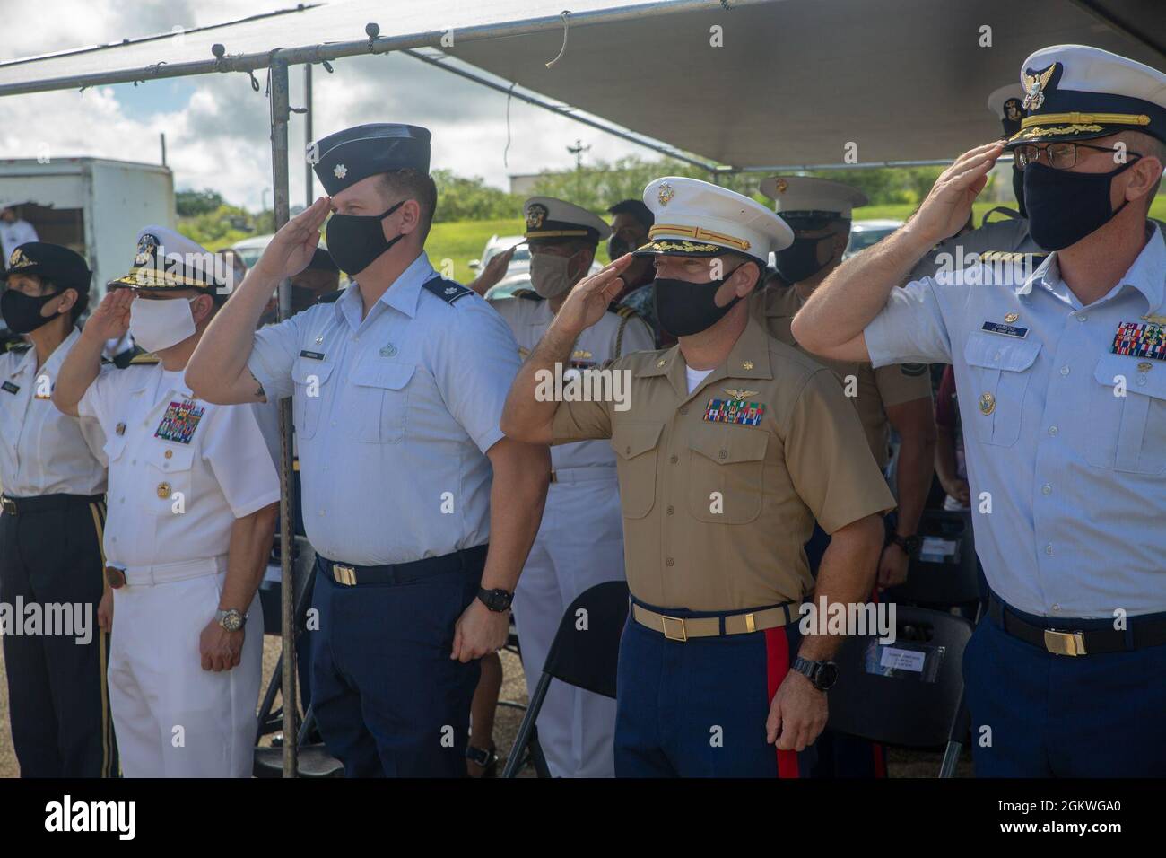 Marine Corps Base (MCB) Camp Blaz senior leaders render a salute during the playing of the national anthem during a wreath laying ceremony and memorial service at the Kǻlaguak memorial in Barrigada, Guam, July 9, 2021. The Kǻlaguak memorial is located at the site of a former Japanese military airfield. The memorial service was among the many held across the island to commemorate the liberation of Guam during World War II in 1944. Stock Photo