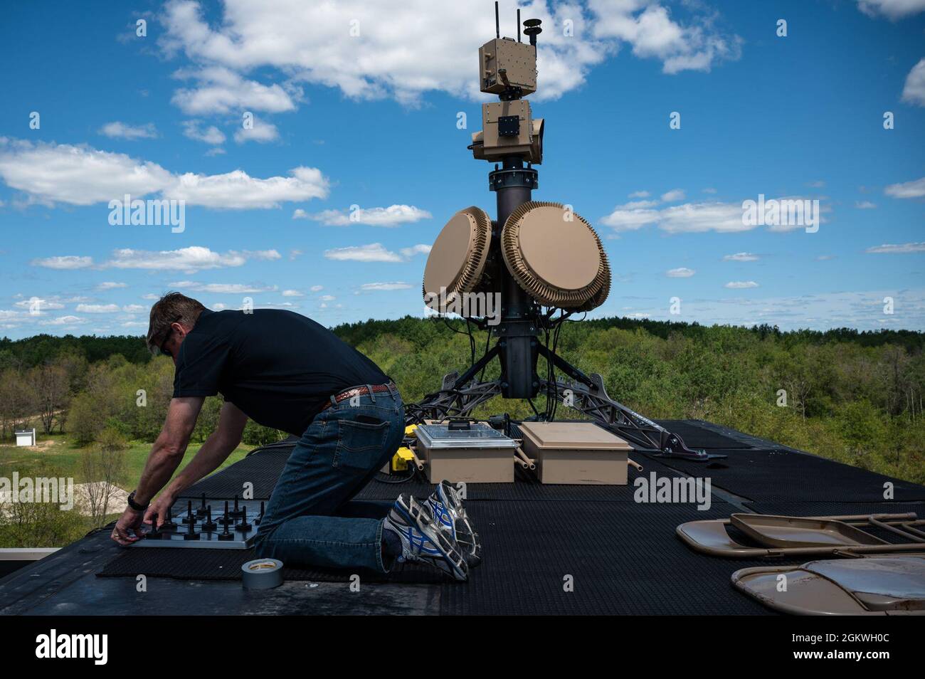 Greg Gillenger, Combined joint all-domain command and control advanced battle management system, sets up an Anduril Industries tower that will support Global Information Dominance Experiment 3 and Architect Demonstration Evaluation 5 at Camp Grayling, Michigan, July, 9, 2021. North American Aerospace Defense Command and U.S. Northern Command, NORAD and USNORTHCOM, in partnership with all 11 Combatant Commands, led the third in a series of Global Information Dominance Experiments designed to rapidly develop the capabilities required to increase deterrence options in competition and crisis throu Stock Photo