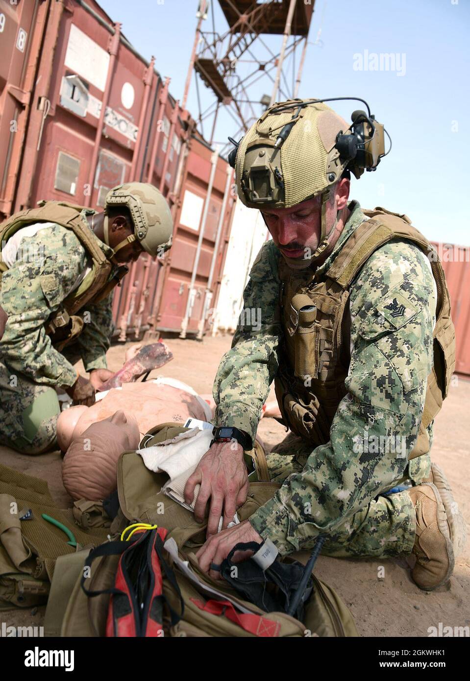 CAMP LEMMONIER, Djibouti (July 10, 2021)  U.S. Navy Information Systems Technician 2nd Class Raymond Edwards from Houston and Gunner's Mate 1st Class David Sewell from Postfalls, Id. apply combat field care to a mannequin during Tactical Combat Casualty Care (TCCC) training taught by U.S. Navy Maritime Expeditionary Security Squadron 11 (MSRON 11). TCCC was developed by the U.S. Department of Defense, Defense Health Agency (DHA) Joint Trauma System to teach evidence-based, life-saving techniques and strategies for providing the best trauma care on the battlefield. While there is no replacement Stock Photo