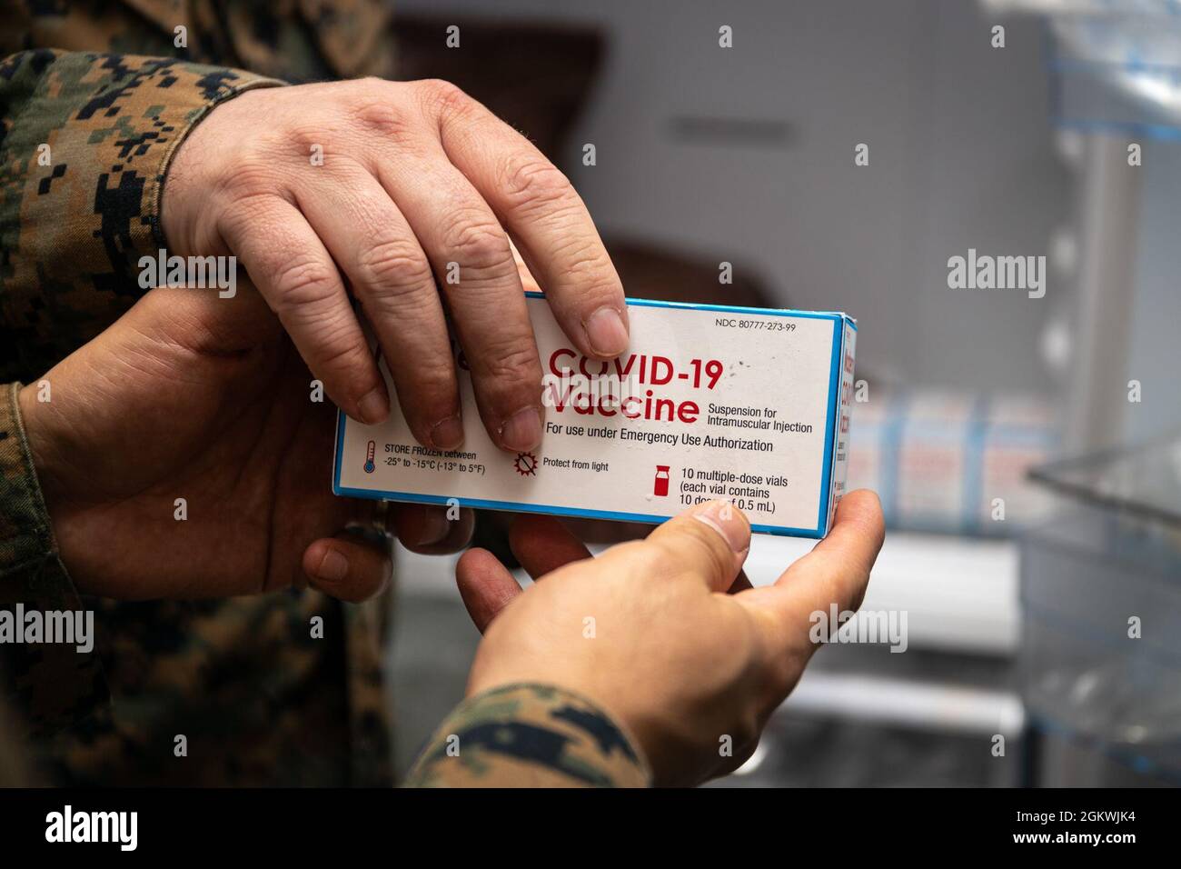 A U.S. Navy Hospital Corpsman with Marine Rotational Force - Darwin holds a COVID-19 vaccine at Robertson Barracks, Darwin, NT, Australia, July 10, 2021. The vaccines arrived at Royal Australian Air Force Base Darwin and were distributed to Larrakeyah and Robertson Barracks medical facilities to vaccinate U.S. service members in Australia’s Top End. The Marines and Sailors of MRF-D 21.2 have successfully observed all COVID-19 mitigation procedures required by the Australian and U.S. governments to travel to the Northern Territory and now fall under protocols set by the local government. Stock Photo