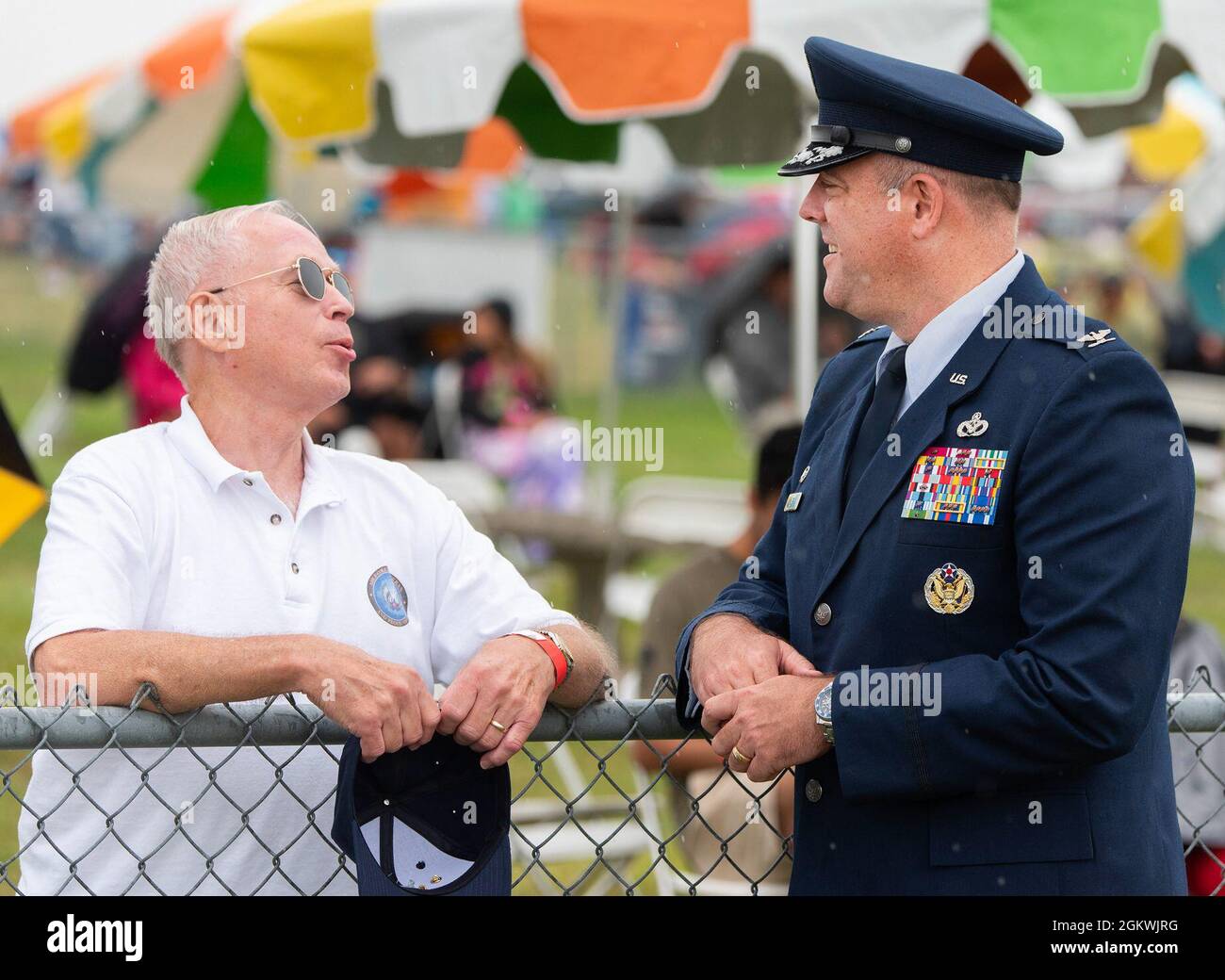 Col. Patrick Miller, 88th Air Base Wing and Wright-Patterson Air Force Base commander, chats with a Dayton Air Show attendee at Dayton International Airport on July 10, 2021. In addition to flying demonstrations, the crowd was able to visit with Airmen and see displays of Air Force attack aircraft, cargo planes and tankers. Stock Photo