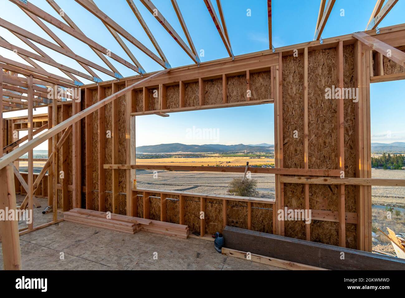 A new construction home being framed on a hillside with a view overlooking Spokane Valley and Liberty Lake, Washington, USA Stock Photo