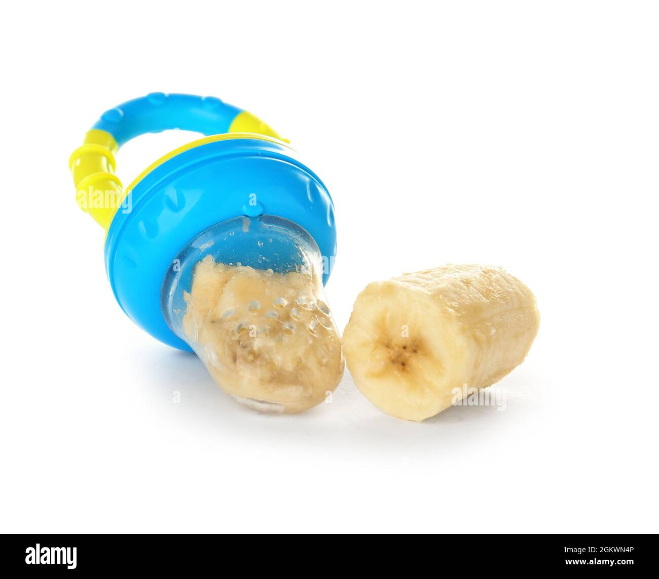 Baby's nibbler and banana on white background Stock Photo Alamy