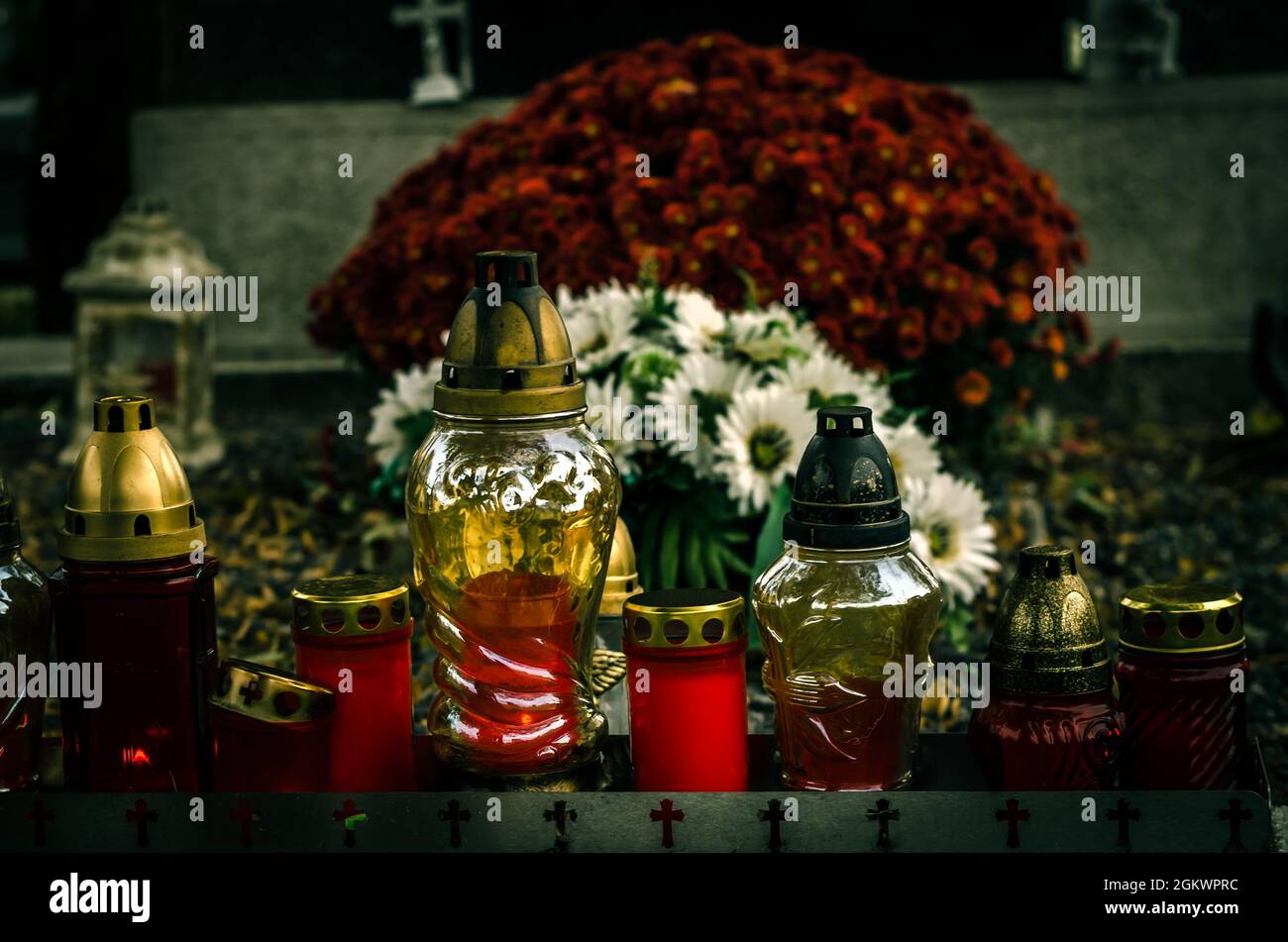 burning candles, chrysanthemum flowers and funeral religious