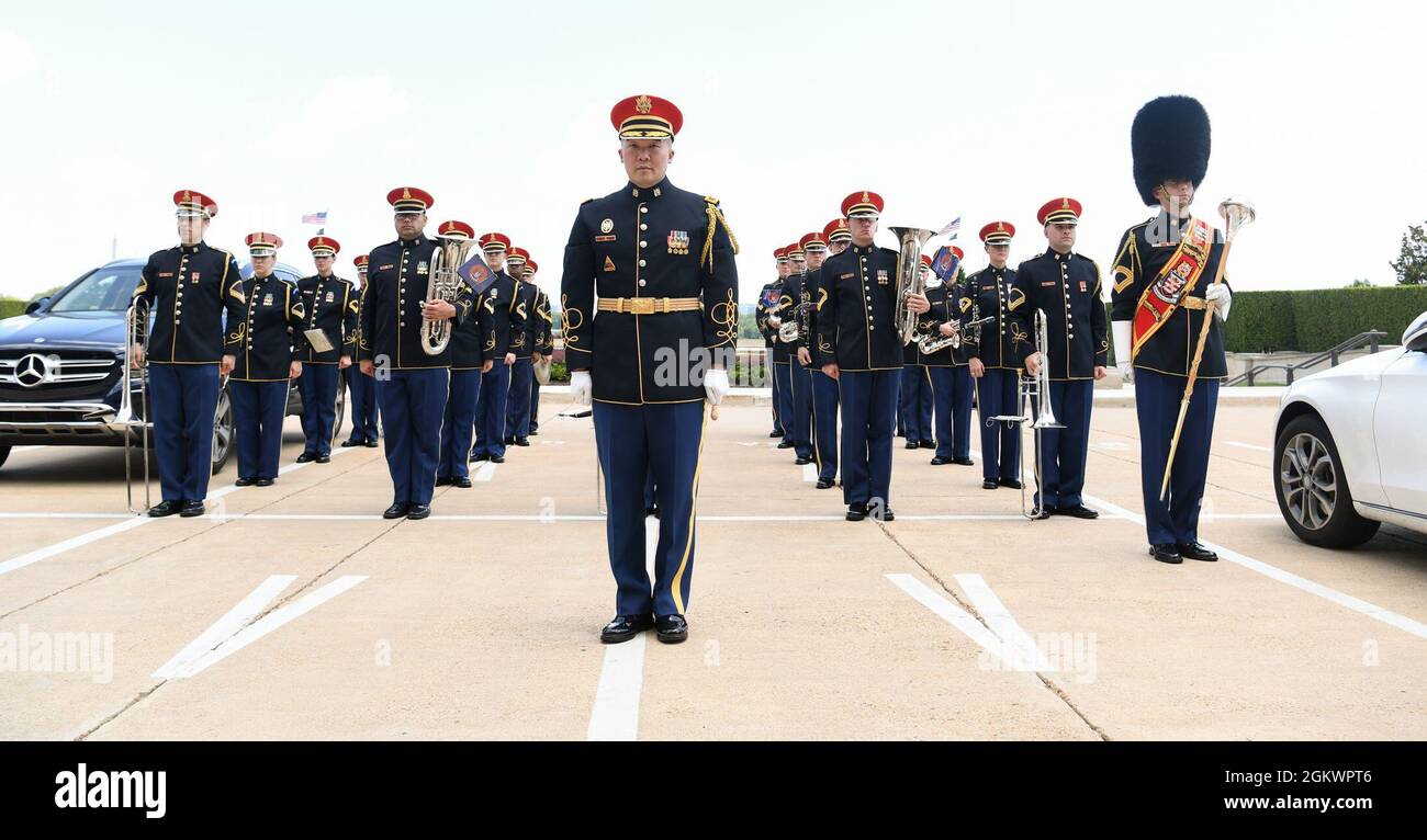 U.S. Army Maj. Dae Kim, associate conductor with the U.S. Army Band and other members of the band stand at attention during an Armed Forces Full Honor Cordon in honor of Secretary of the Defense of the United Kingdom Ben Wallace at the Pentagon in Arlington, Va., July 12, 2021. The event was hosted by Secretary of Defense Lloyd J. Austin III and included the U.S. Army Band 'Pershing's Own'. Stock Photo