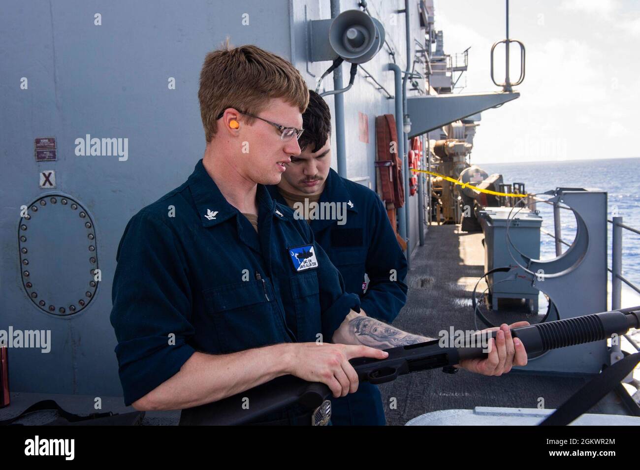 210712-N-RG587-1469 ATLANTIC OCEAN (July 12, 2021) Gunner's Mate 3rd Class David Cook, left, gives M500 shotgun training to Quartermaster 3rd Class Caleb Richards aboard the Ticonderoga-class guided-missile cruiser USS Vella Gulf (CG 72), during a small arms qualification course in the Atlantic Ocean, July 12. Vella Gulf is underway in the Atlantic Ocean conducting operations as part of the Dwight D. Eisenhower Carrier Strike Group. Stock Photo