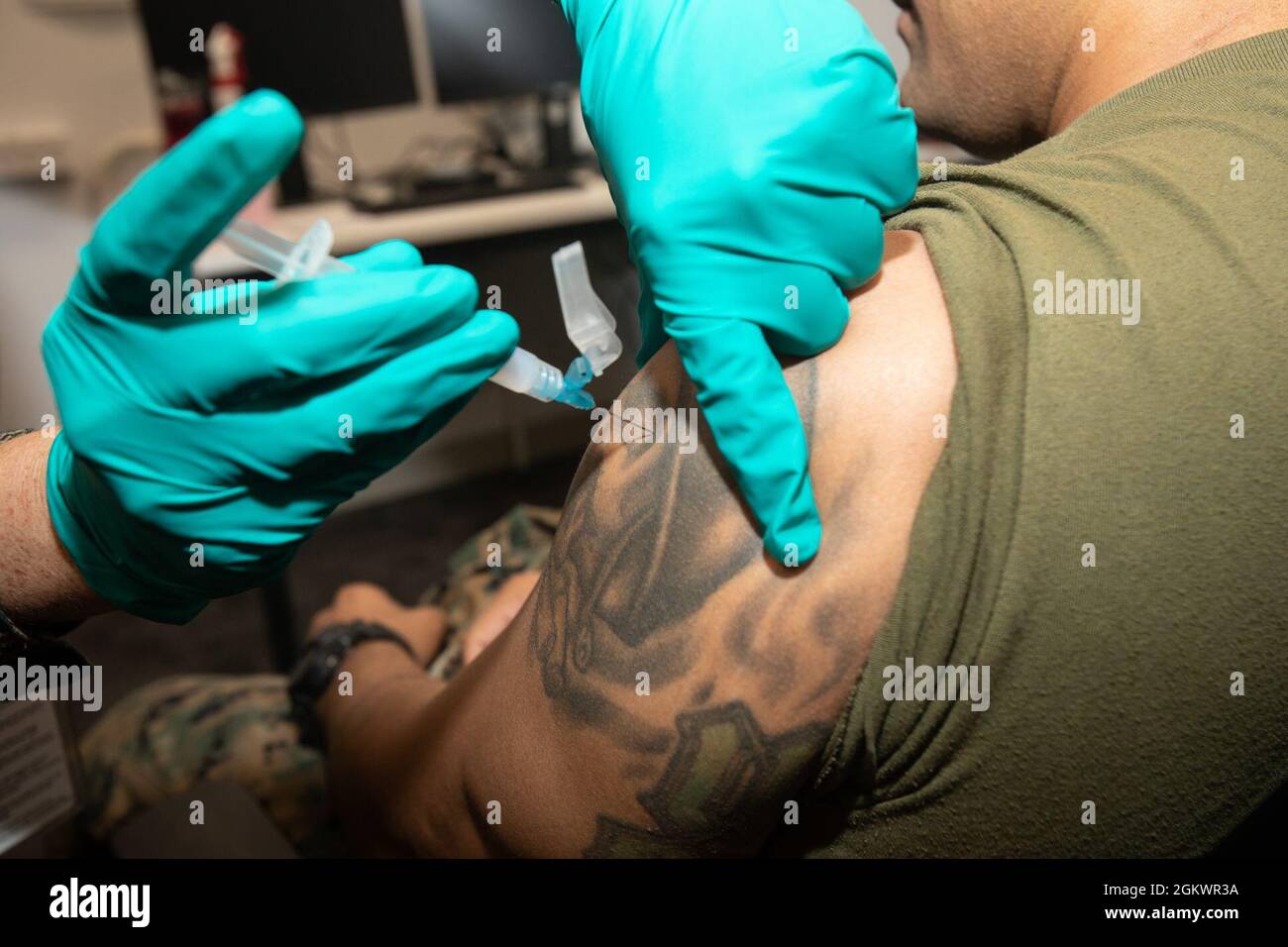 A U.S. Marine with Marine Rotational Force - Darwin receives a dose of the COVID-19 vaccine at Larrakeyah Barracks, Darwin, NT, Australia, July 12, 2021. COVID-19 and influenza vaccines were transported to Larrakeyah and Robertson Barracks medical facilities to vaccinate U.S. service members in Australia’s Top End. The Marines and Sailors of MRF-D 21.2 successfully adhered to all COVID-19 mitigation procedures required by the Australian and U.S. governments to travel to the Northern Territory and now fall under protocols set by the local government. Stock Photo