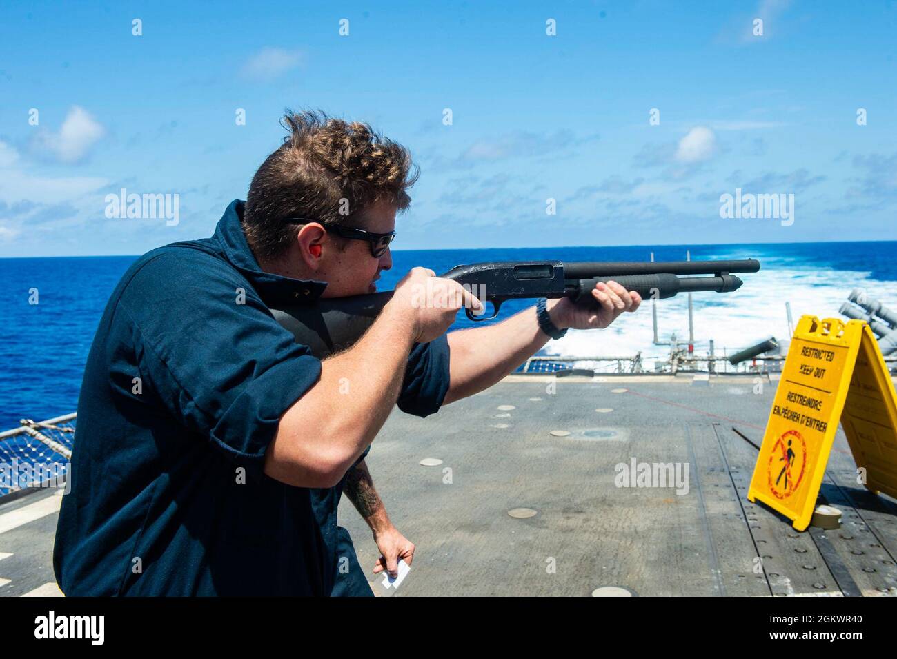 210712-N-RG587-1489 ATLANTIC OCEAN (July 12, 2021) Information Systems Technician 2nd Class Derrick Smith, fires an M500 shotgun aboard the Ticonderoga-class guided-missile cruiser USS Vella Gulf (CG 72), during a small arms qualification course in the Atlantic Ocean, July 12. Vella Gulf is underway in the Atlantic Ocean conducting operations as part of the Dwight D. Eisenhower Carrier Strike Group. Stock Photo