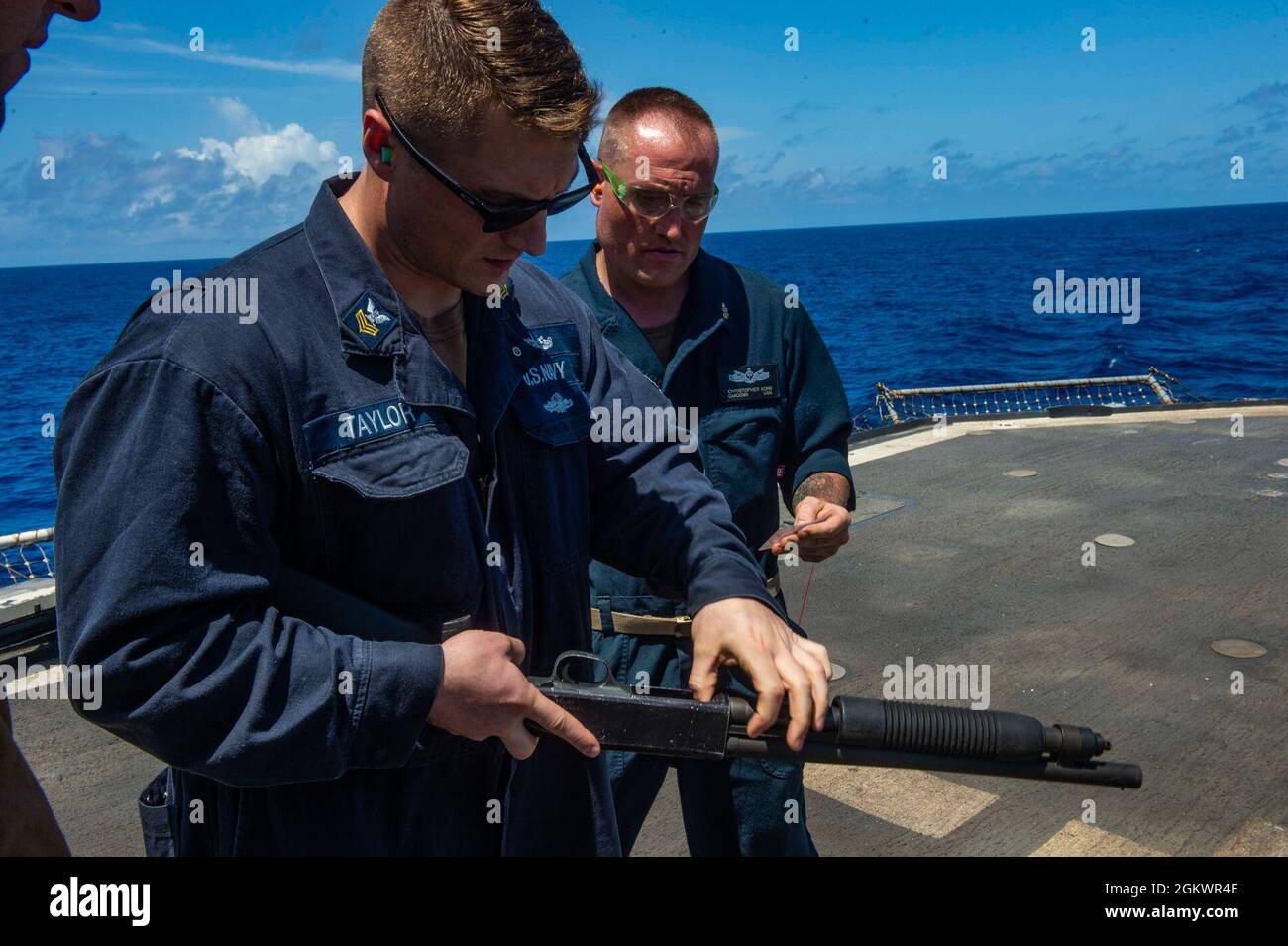 210712-N-RG587-1407 ATLANTIC OCEAN (July 12, 2021) Electronics Technician 1st Class Jason Taylor, loads an M500 shotgun aboard the Ticonderoga-class guided-missile cruiser USS Vella Gulf (CG 72), during a small arms qualification course in the Atlantic Ocean, July 12. Vella Gulf is underway in the Atlantic Ocean conducting operations as part of the Dwight D. Eisenhower Carrier Strike Group. Stock Photo