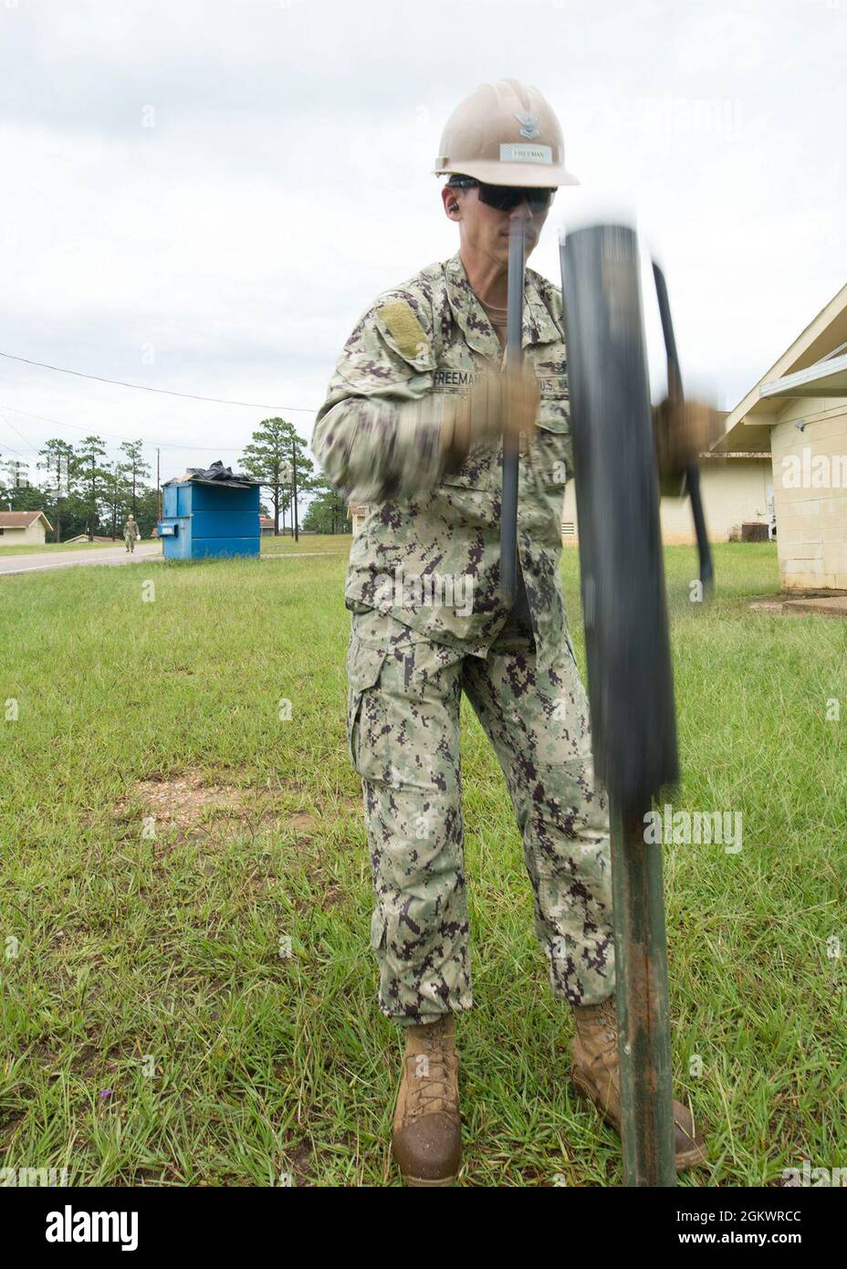 Construction Electrician 2nd Class Blake Freeman, from Marietta, Oklahoma, assigned to U.S. Naval Mobile Construction Battalion (NMCB) 133, uses a stake post driver to secure a stake during a Field Training Exercise (FTX) at Camp Shelby, July 12. FTX is a training evolution where Seabee forces plan and execute multiple mission essential tasks including convoy security, force protection, and camp setup prior to deployment. Stock Photo