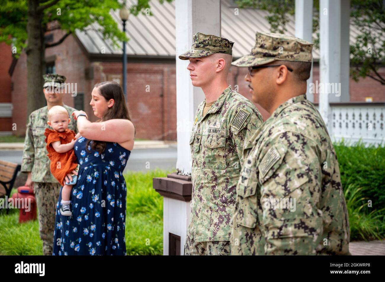 WASHINGTON, DC (July 12, 2021) – Master-at-Arms 2nd Class Tyrell Dugre, center, stands at attention during his reenlistment ceremony, held onboard Washington Navy Yard. Stock Photo