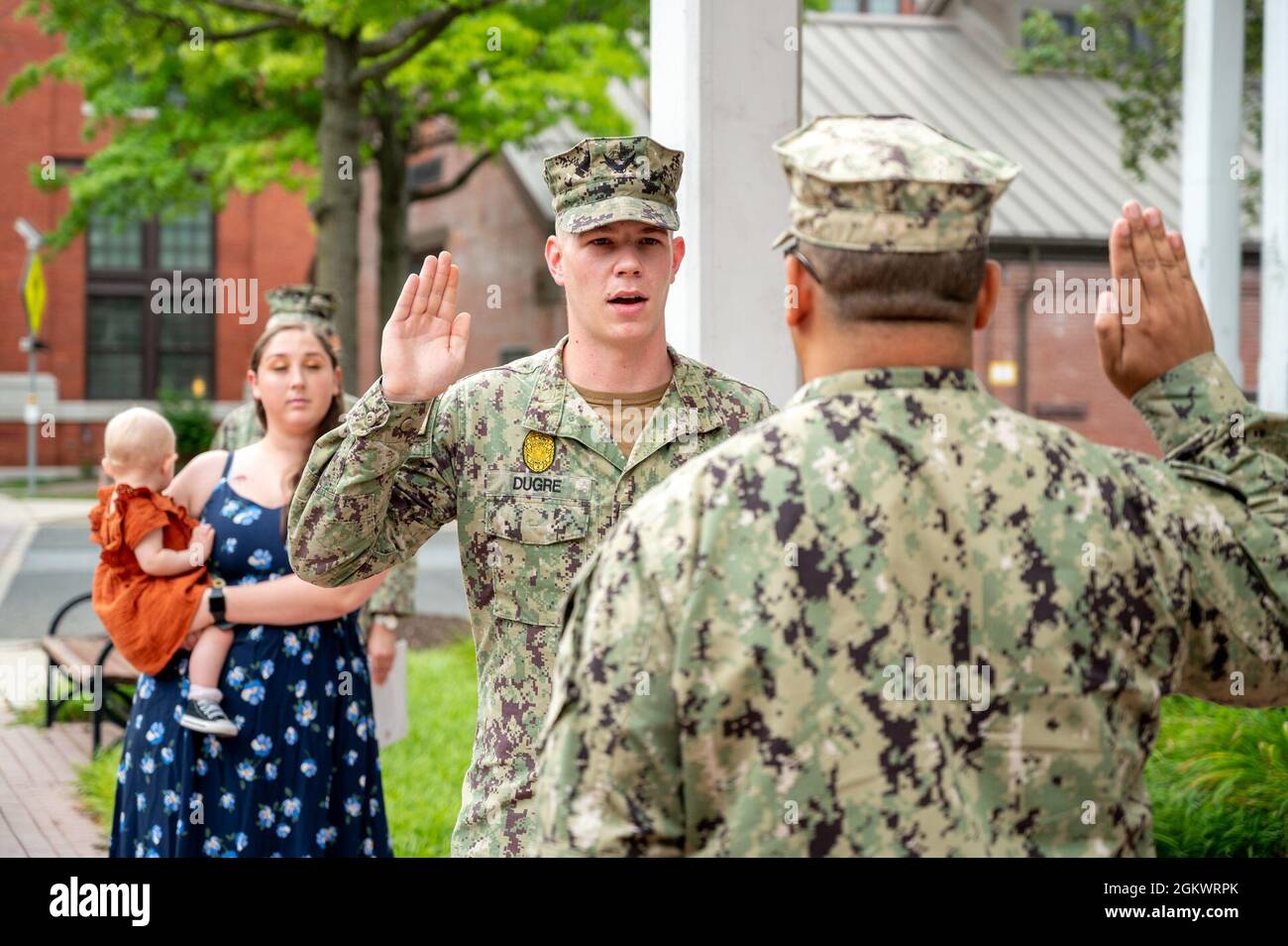 WASHINGTON, DC (July 12, 2021) – Master-at-Arms 2nd Class Tyrell Dugre, center, recites the oath of enlistment onboard Washington Navy Yard. Stock Photo