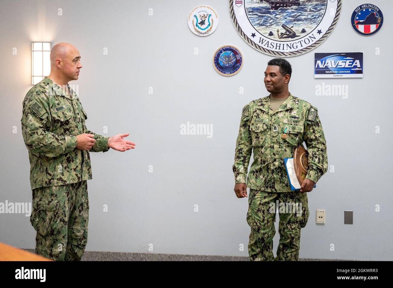 US Navy Engineman 2nd Class Anthony Bartelli (right) holds an