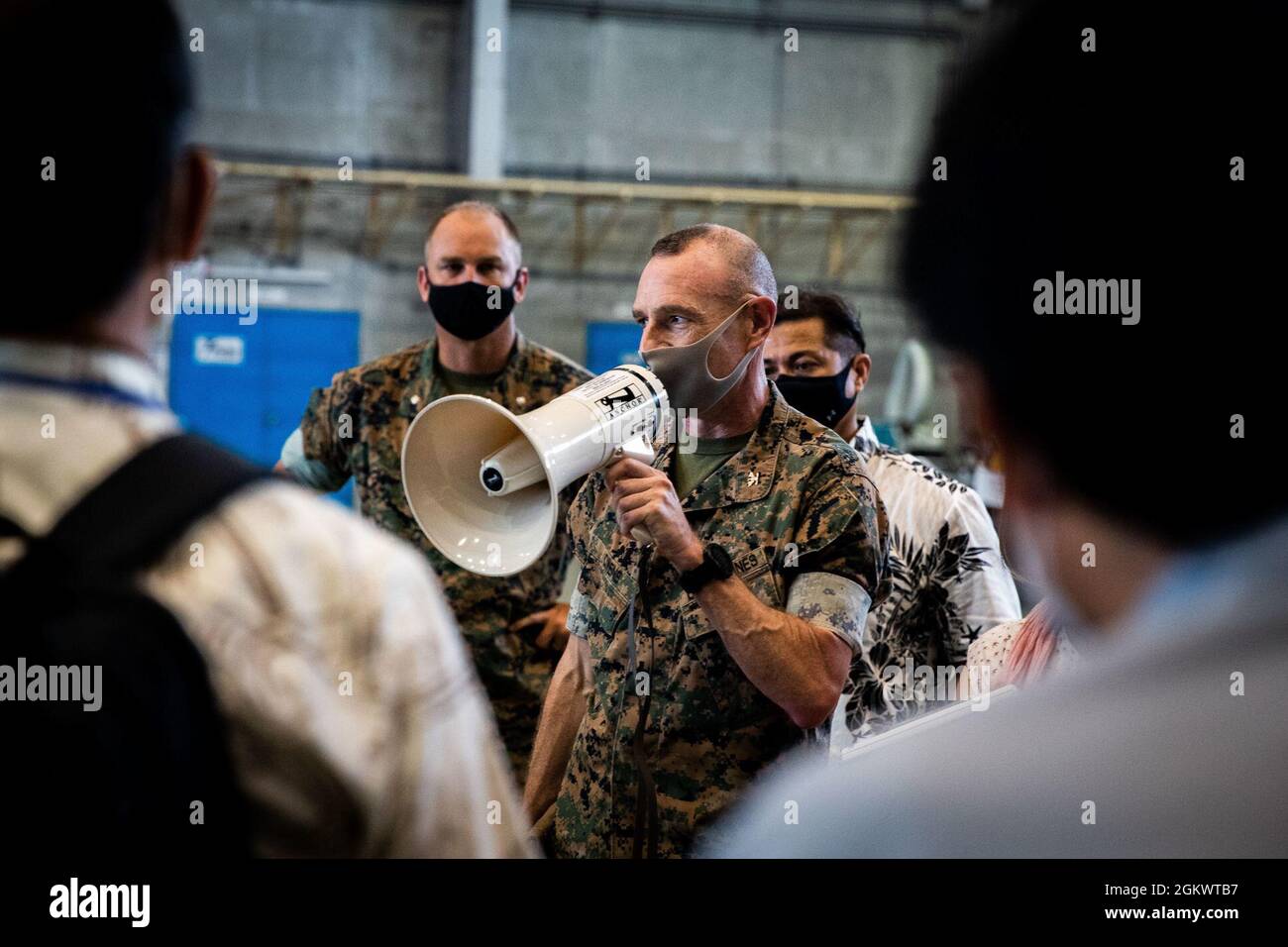 U.S. Marine Corps Col. Neil Owens, assistant chief of staff for government and external affairs, with Marine Corps Installations Pacific (MCIPAC), welcomes locals on Marine Corps Air Station (MCAS)  Futenma, Okinawa, Japan, July 13, 2021. MCIPAC and MCAS Futenma welcomed visitors from the Okinawa Prefectural Government, the City of Ginowan, and the Japanese Government for an onsite brief of the perfluoroalkyl and polyfluoroalkyl (PFAS) Effluent Treatment System (PETS). PETS utilizes proven, mature ion exchange technology to remove PFAS from water which results in water that meets Japanese Envi Stock Photo