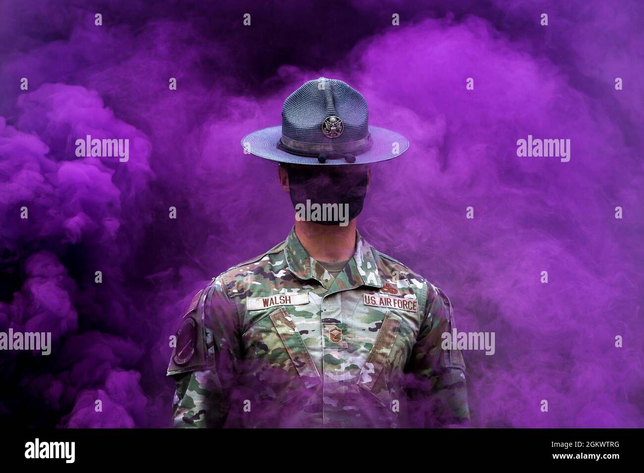 U.S. AIR FORCE ACADEMY, Colo. –  Military Training Instructor MSgt Michael Walsh, walks through purple smoke in the Basic Cadet Training assault course at the U.S. Air Force Academy's Jacks Valley in Colorado Springs, Colo., on July 13, 2021. Basic Cadet Training (BCT) is a six-week indoctrination program to guide the transformation of new cadets from being civilians to military academy cadets prepared to enter a four-year officer commissioning program. Stock Photo