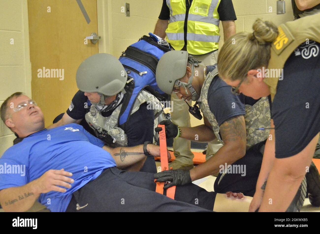 Donny Plaster, assistant chief of training, Fort Campbell Fire and Emergency Services, left, works with Wes LaFortune, district chief, Fort Campbell Fire and Emergency Services, center, and Sgt. Thomasa Munroe, Montgomery County Sheriff’s Office, to prepare a shooting victim for medical evacuation during Active Attack Integrated Response training, hosted July 12-16 at Jackson Elementary School. Stock Photo