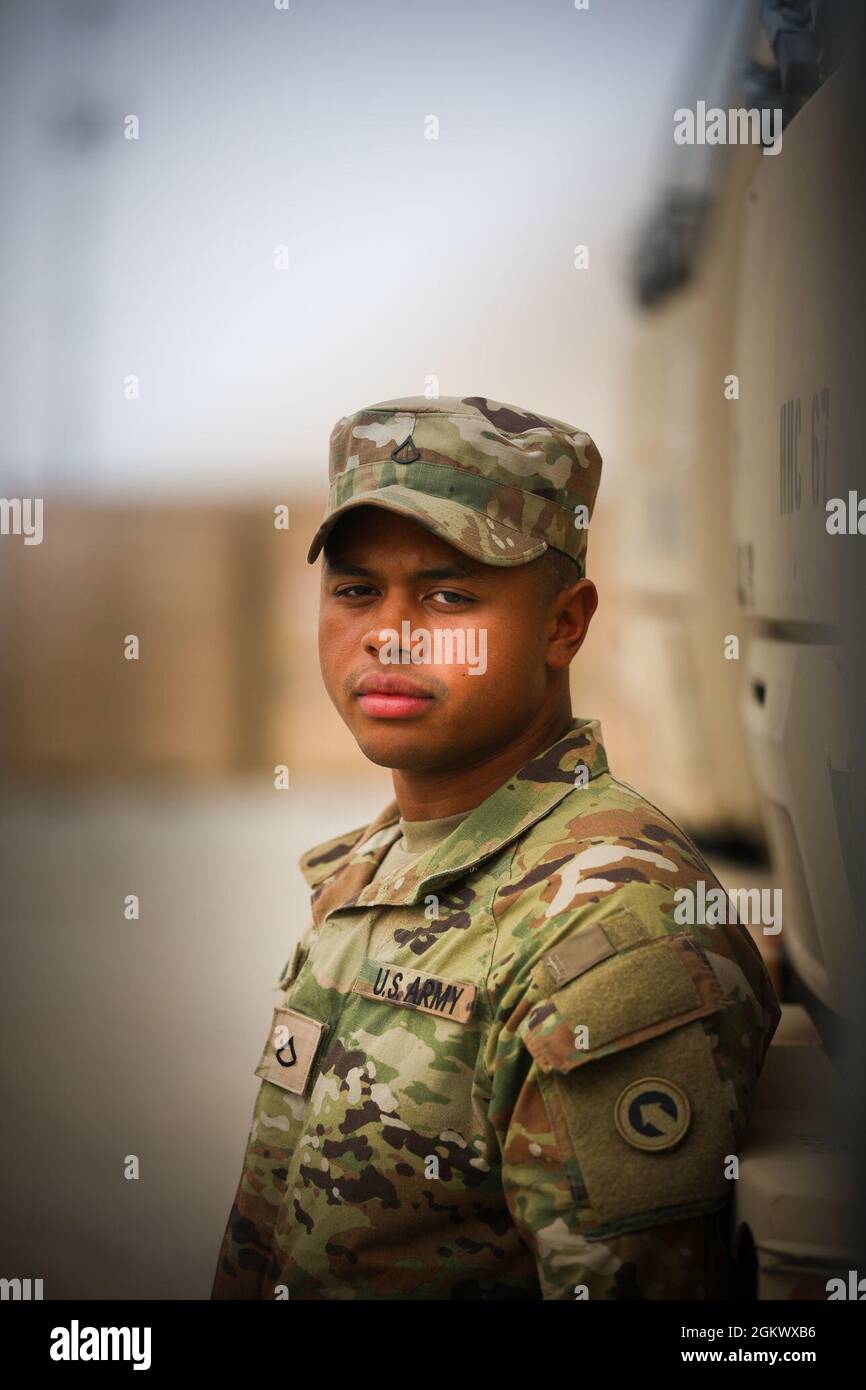 Pfc. Andre Ogburn, human resources specialist, A Company, 1st Theater Sustainment Command, manages the S1 operations for the 1st TSC (Forward) at Camp Arifjan, Kuwait, July 16, 2021. Ogburn, who is from Honolulu, Hawaii, completed his Basic Combat Training and Advanced Individual Training at Fort Jackson, South Carolina. His father, retired Sgt. 1st Class Vernon Johnson, served for 21 years as an automated logistical specialist and is the reason Ogburn decided to join the Army. Ogburn wants his family back home to know he loves them and cannot wait to see them again. Stock Photo