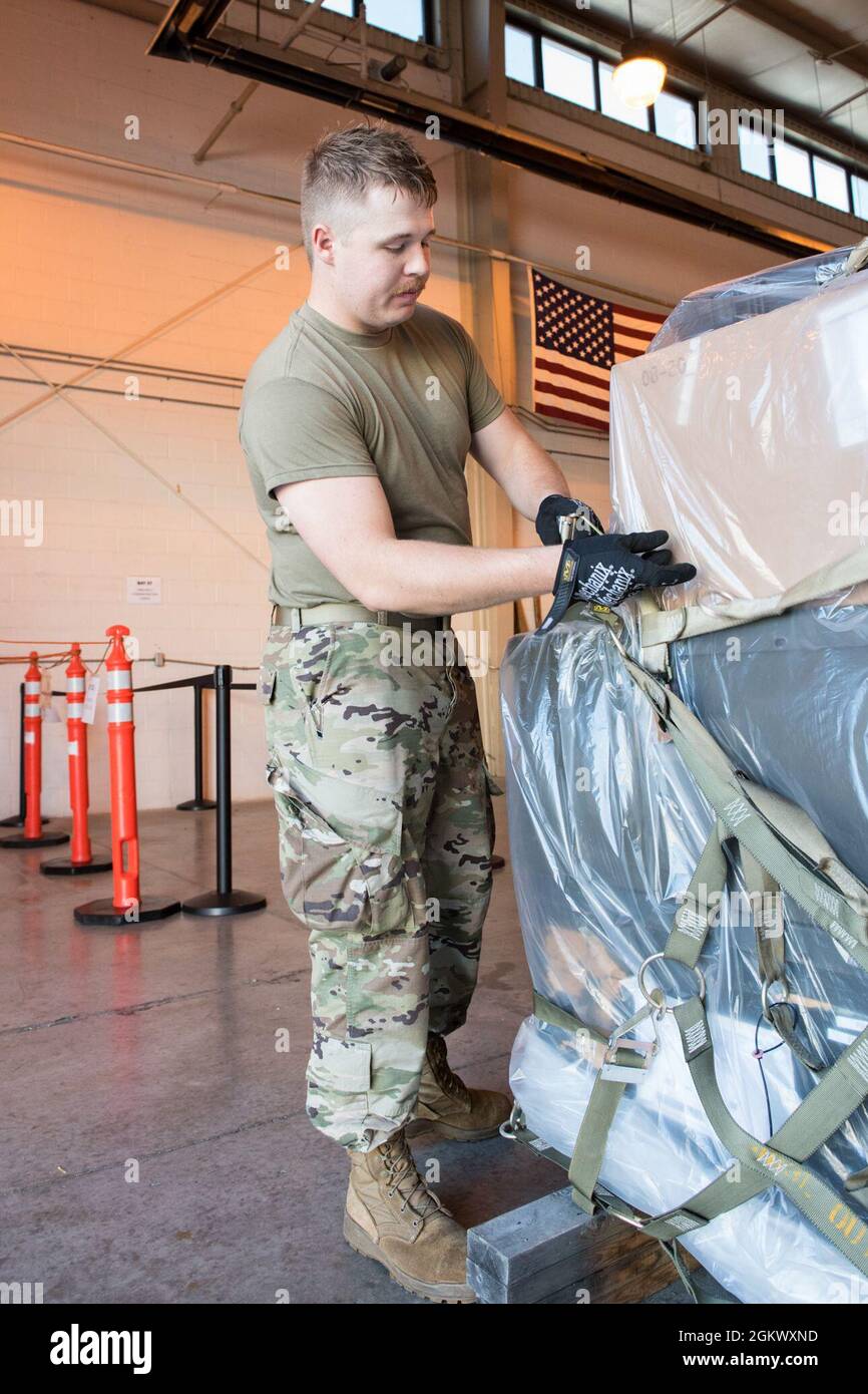 U.S. Air Force Senior Airman Steve Shaffer, an aerial transportation specialist with the 123rd Airlift Wing, Kentucky National Guard, secures cargo onto a pallet during a pallet building exercise at the 167th Airlift Wing, Martinsburg, West Virginia, Jul. 13, 2021. The 167th hosted members from the 123rd for a small air terminal training in preparation for their upcoming deployment. Stock Photo