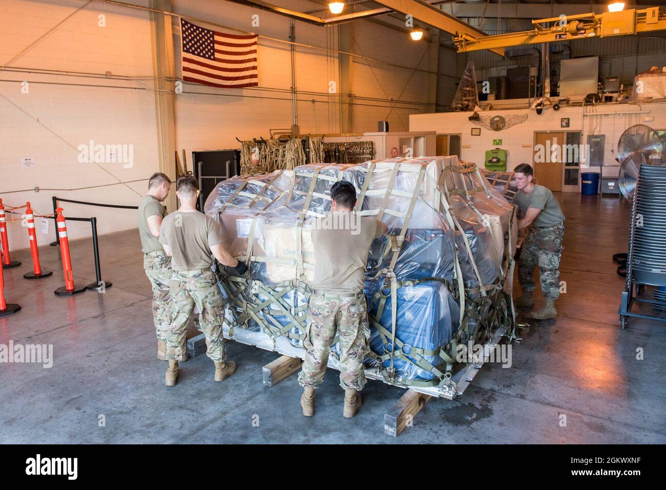 Aerial transportation specialists from the 123rd Airlift Wing, Kentucky National Guard, palletize cargo during a pallet building exercise at the 167th Airlift Wing, Martinsburg, West Virginia, Jul. 13, 2021. The 167th hosted members from the 123rd for a small air terminal training in preparation for their upcoming deployment. Stock Photo