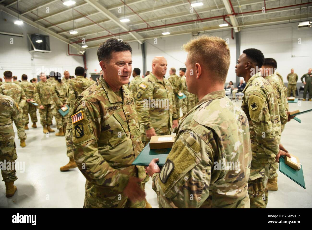 Brigadier General Jonathan S. Hubbard, Commander of the 184th Sustainment Command, awards and speaks to a soldier at the COVID awards ceremony in Meridian, Mississippi on July 13, 2021. The Mississippi National Guard deployed over 1,700 guardsmen to work alongside MSDH and MEMA to fight the spread of COVID-19 during the pandemic. Stock Photo