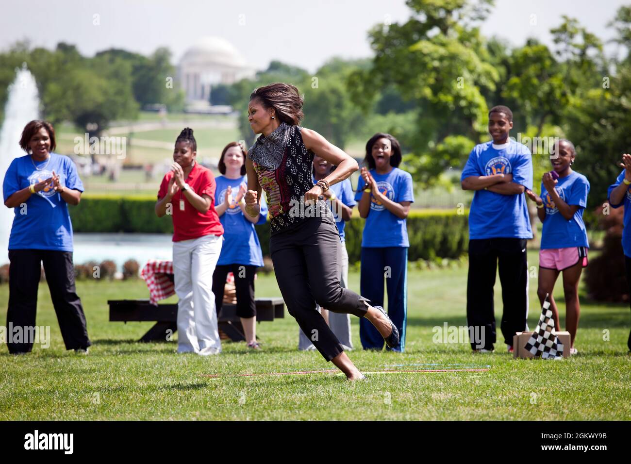 First Lady Michelle Obama participates in the ÒPit Crew ChallengeÓ  during an event with the President's Council on Fitness, Sports and Nutrition on the South Lawn of the White House, May 9, 2011. The First Lady visited seven activity stations during the event, which helped promote both the Let's Move! and Joining Forces initiatives. (Official White House Photo by Chuck Kennedy)  This official White House photograph is being made available only for publication by news organizations and/or for personal use printing by the subject(s) of the photograph. The photograph may not be manipulated in an Stock Photo